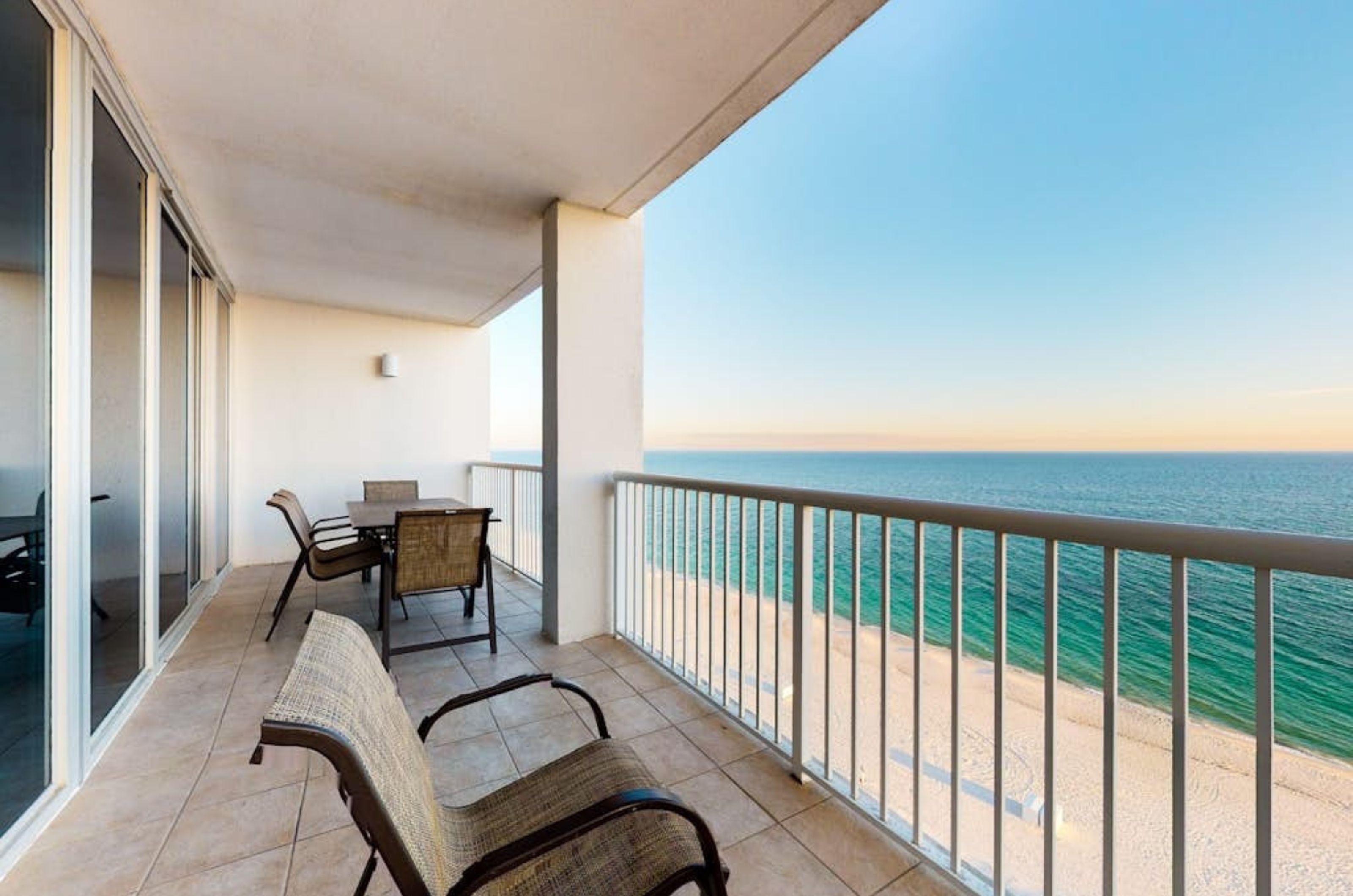 A long private balcony with lounge chairs overlooking the Gulf of Mexico at Island Tower 