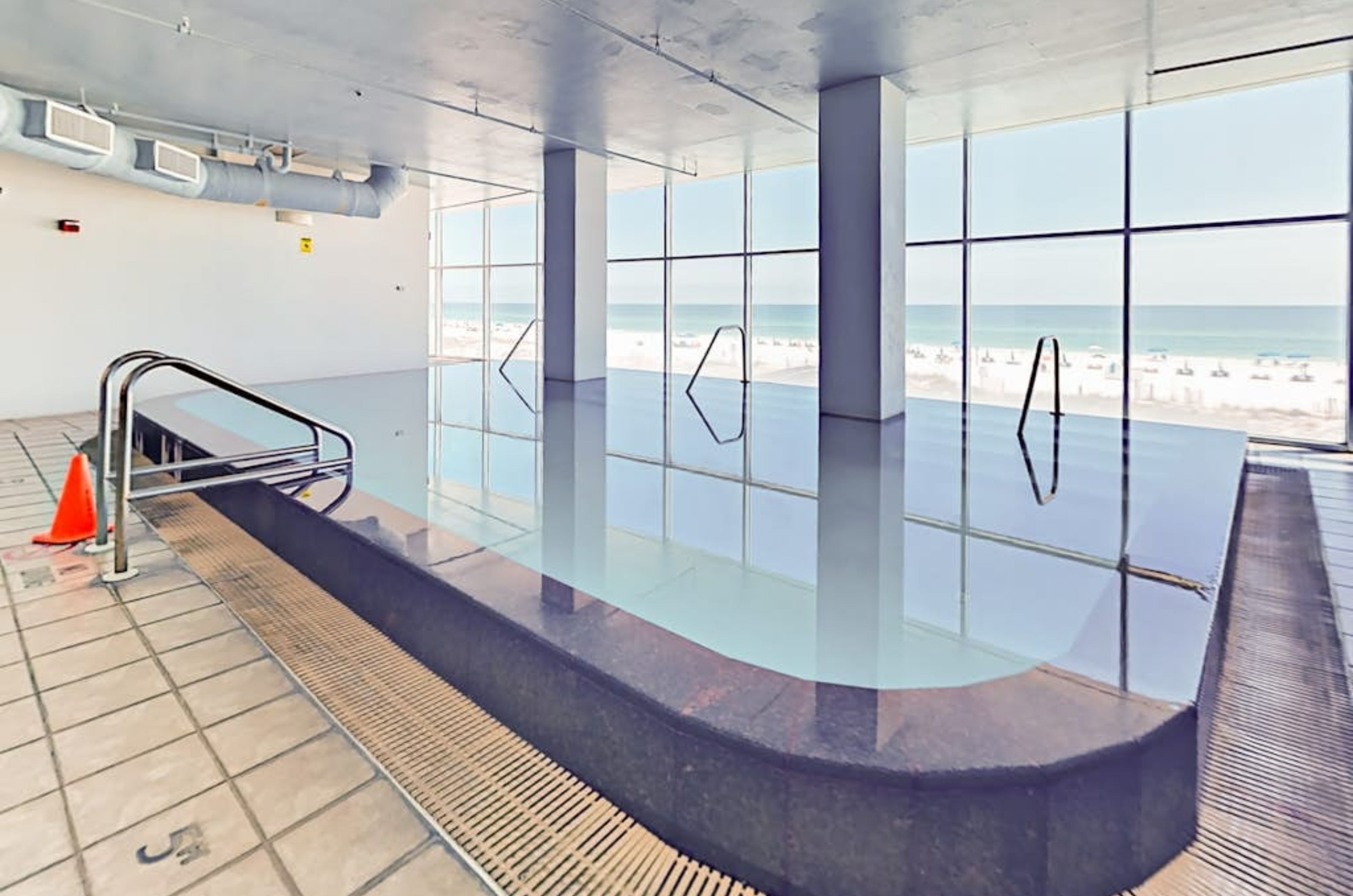 The indoor swimming pool next to windows facing the Gulf at Island Tower in Gulf Shores Alabama 