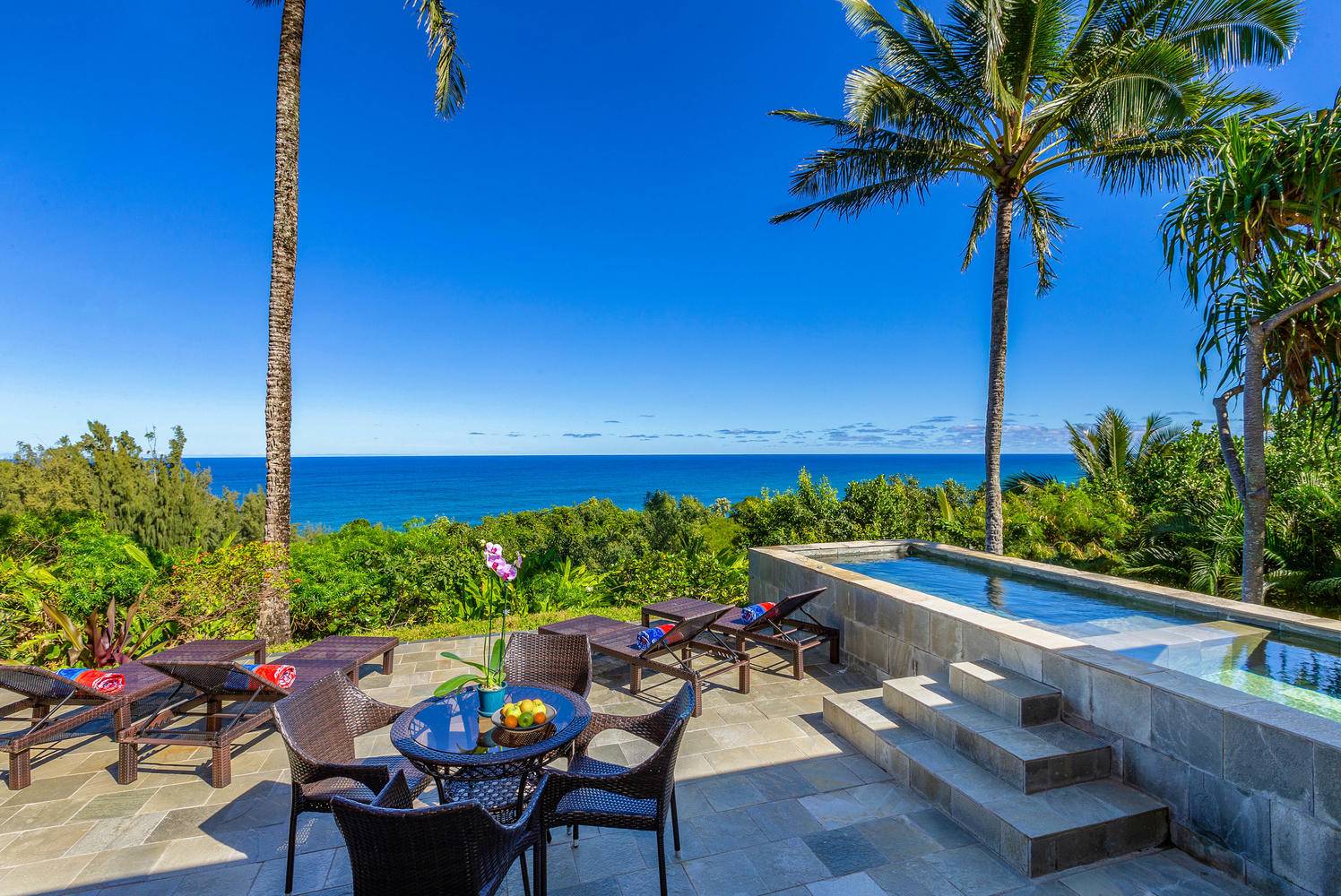 Perched on an cean bluff above the surf  a 3-bedroom 4-bath Kauai vacation home rental offers panoramic ocean views.