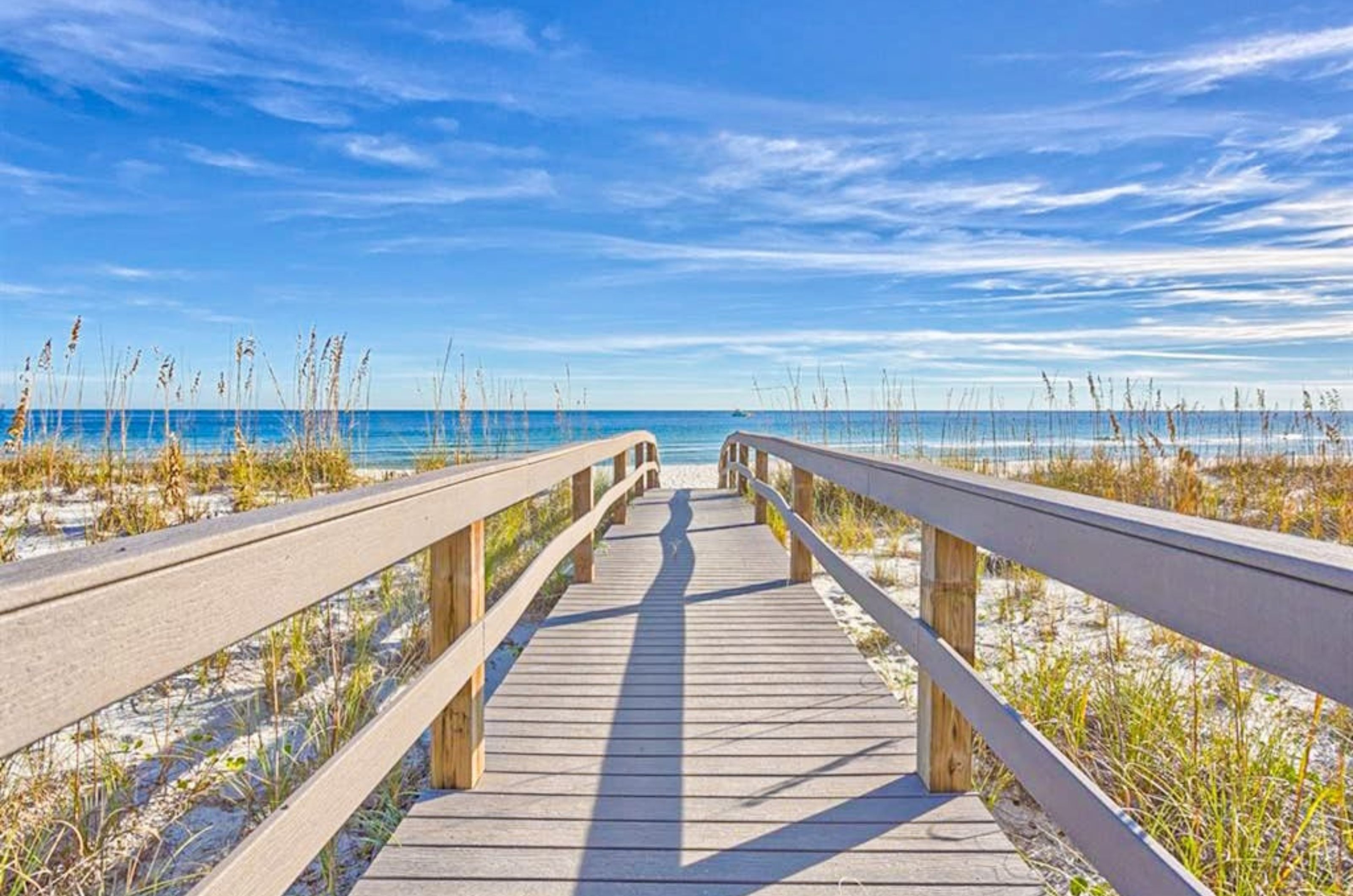 A wooden boardwalk leading to the Gulf at Marlin Key in Orange Beach Alabama 