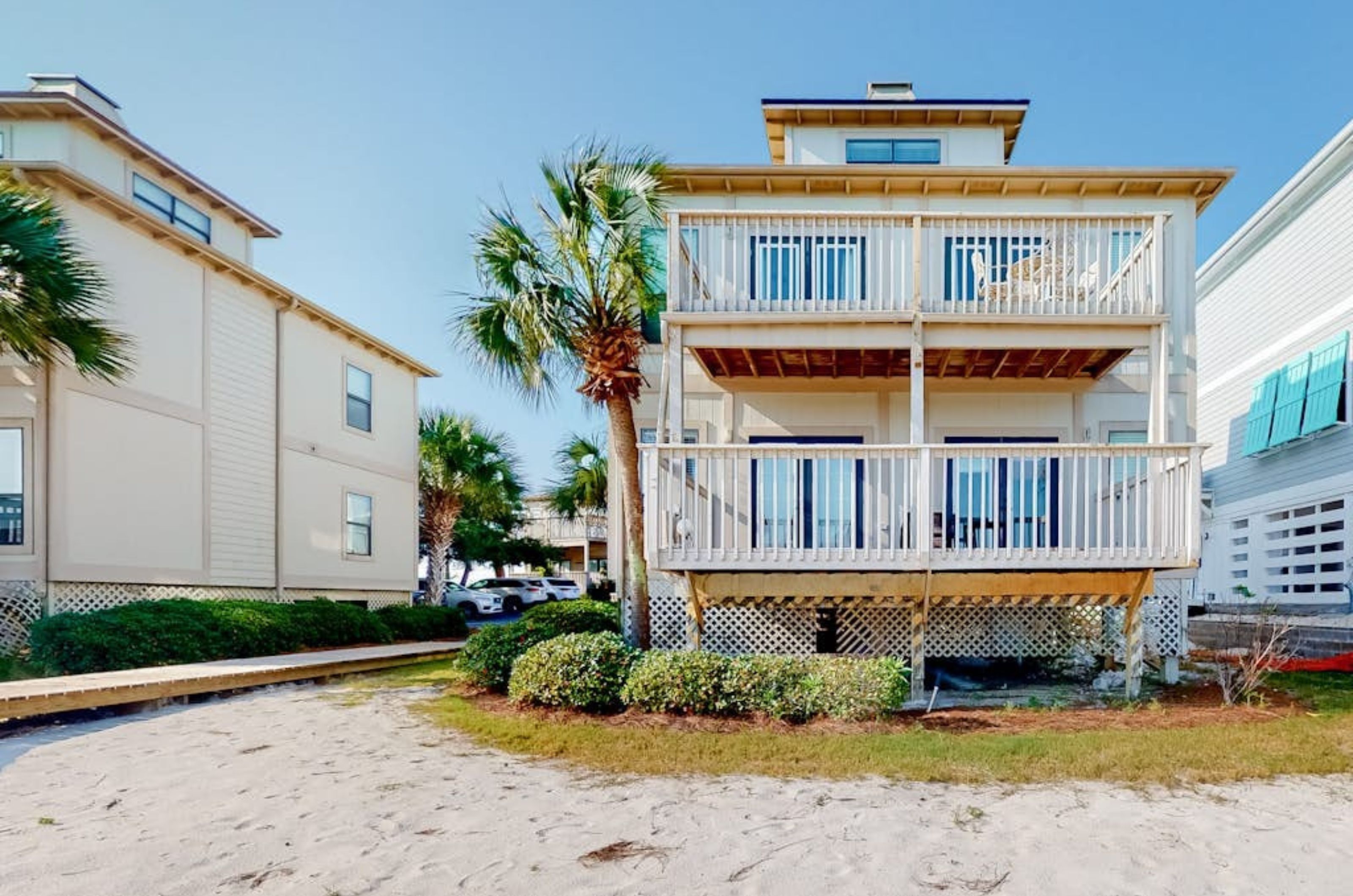 The beachside exterior of one townhome with a private balcony at Molokai Villas in Perdido Key Florida 