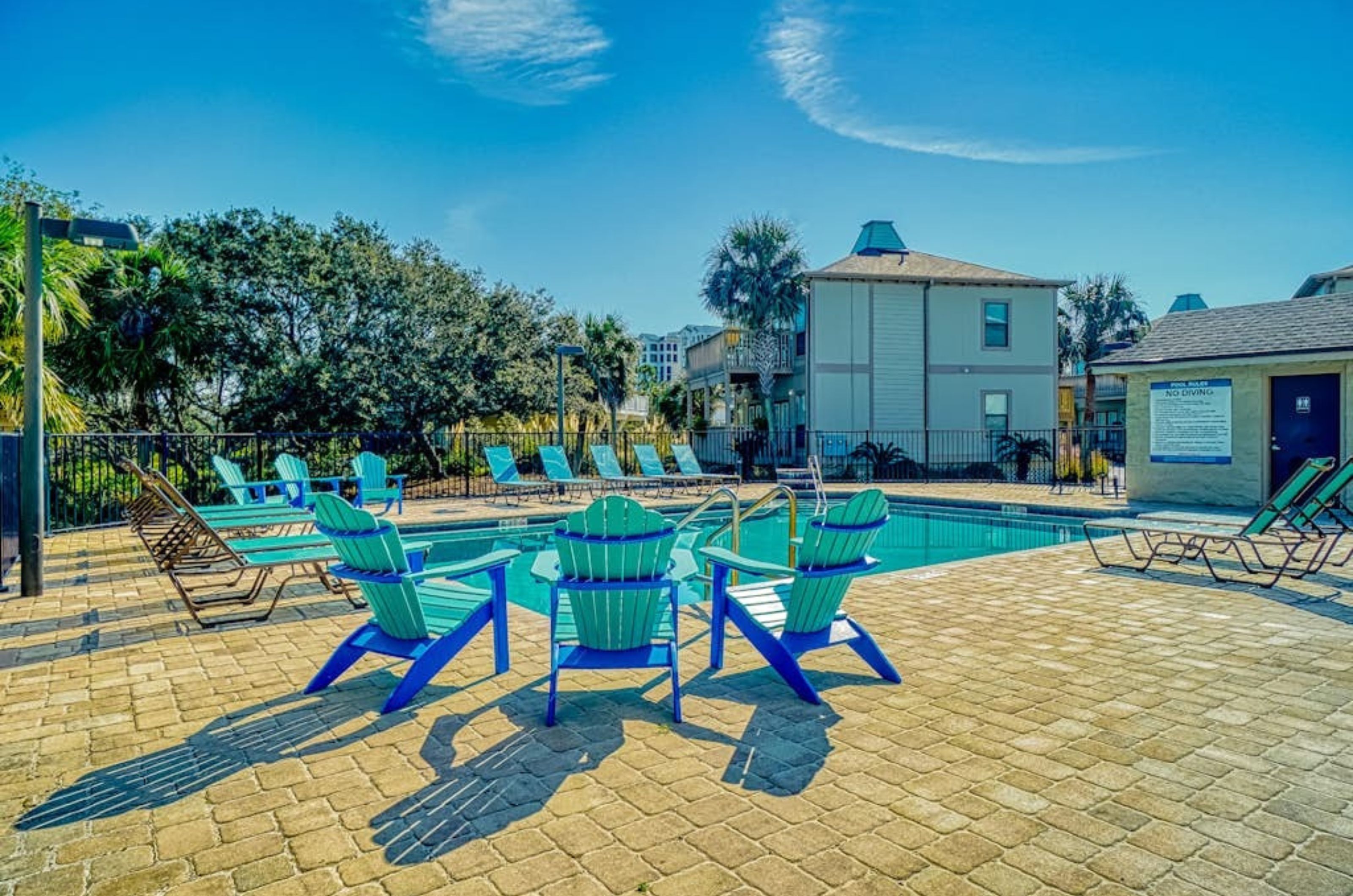 The outdoor pool and pool deck with lounge chairs at Molokai Villas