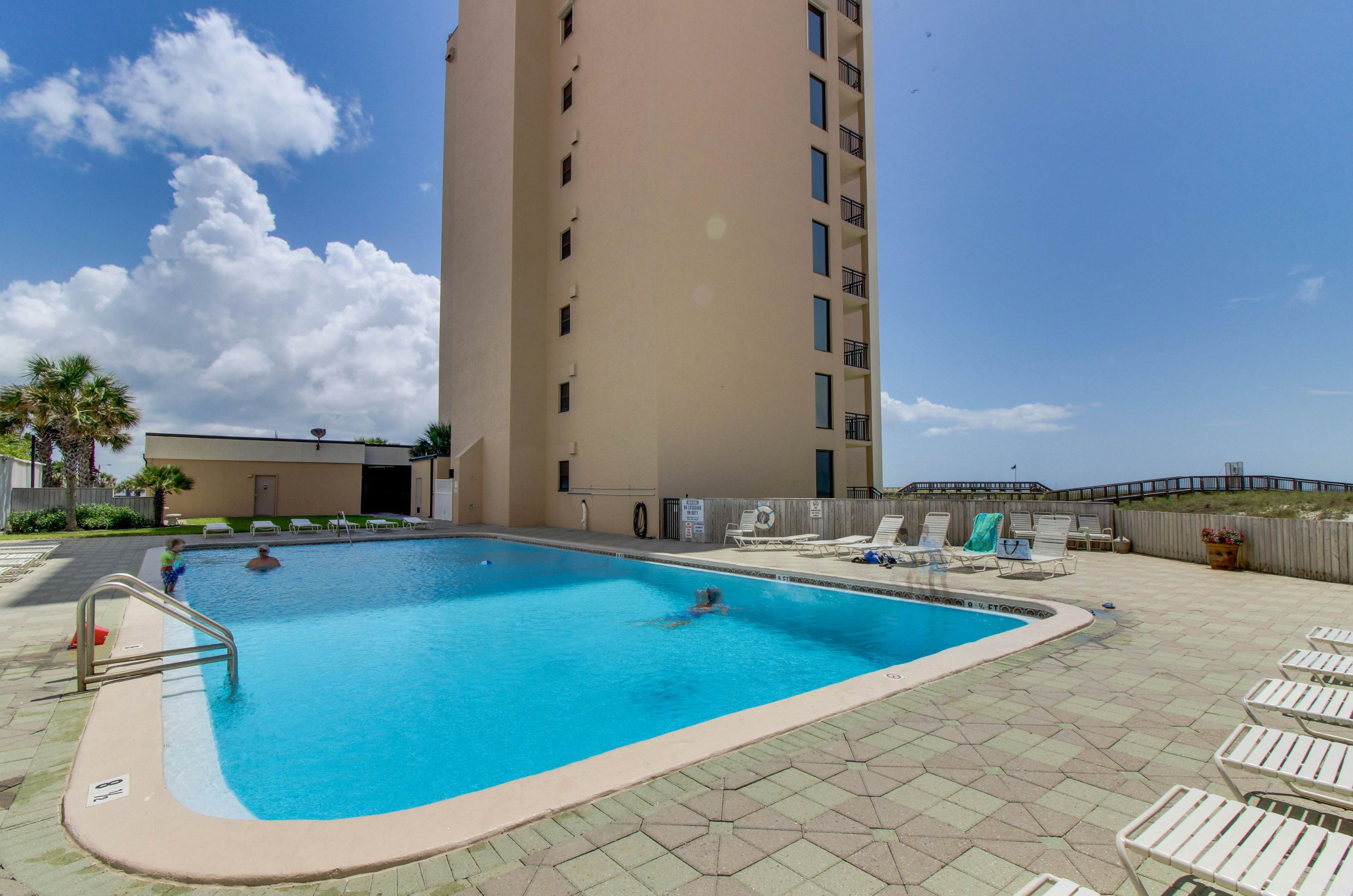 Outdoor swimming pool and sun deck next to Navarre Towers 