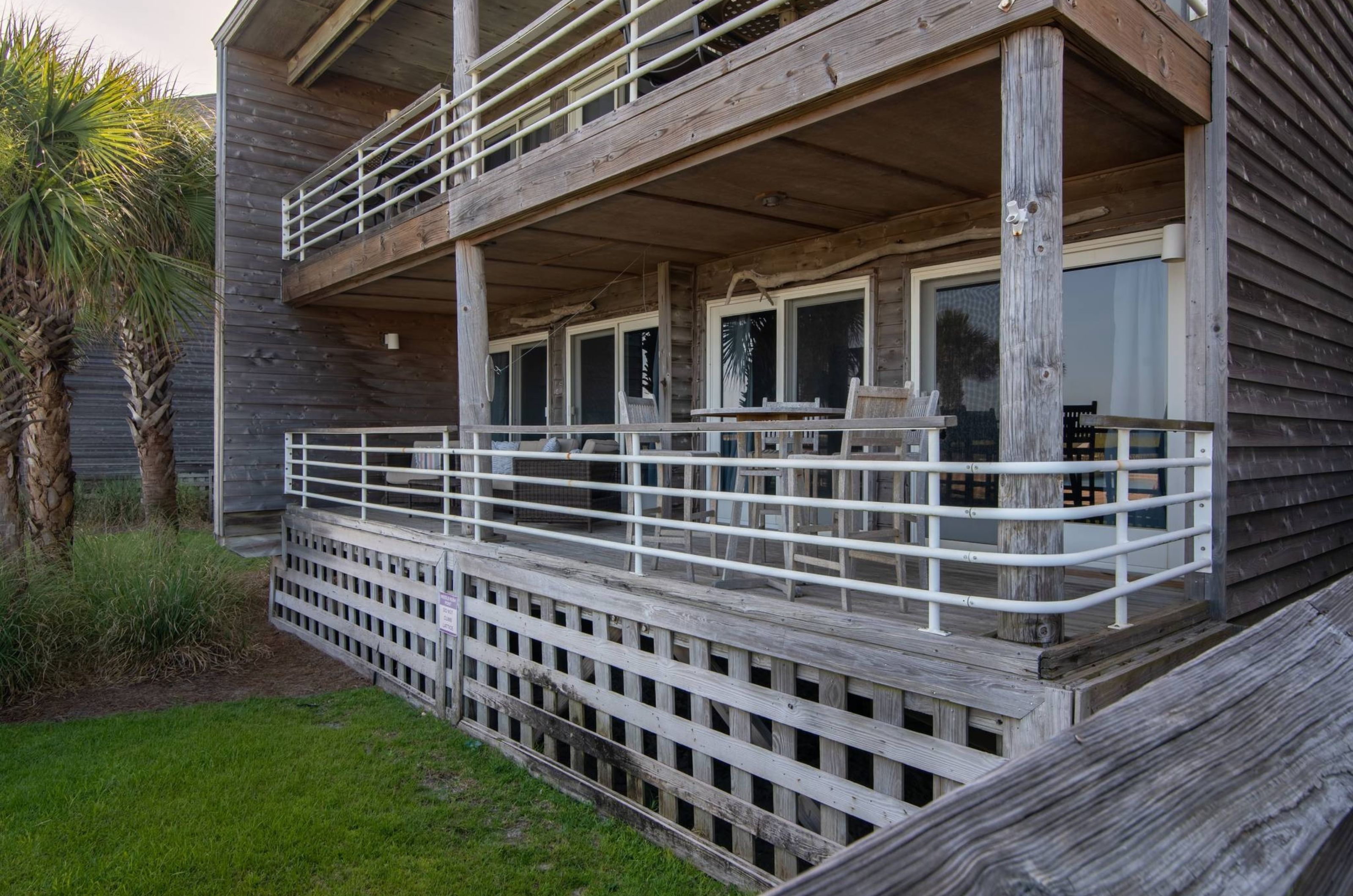 View of the exterior of a private balcony with chairs at Needle Rush Point 