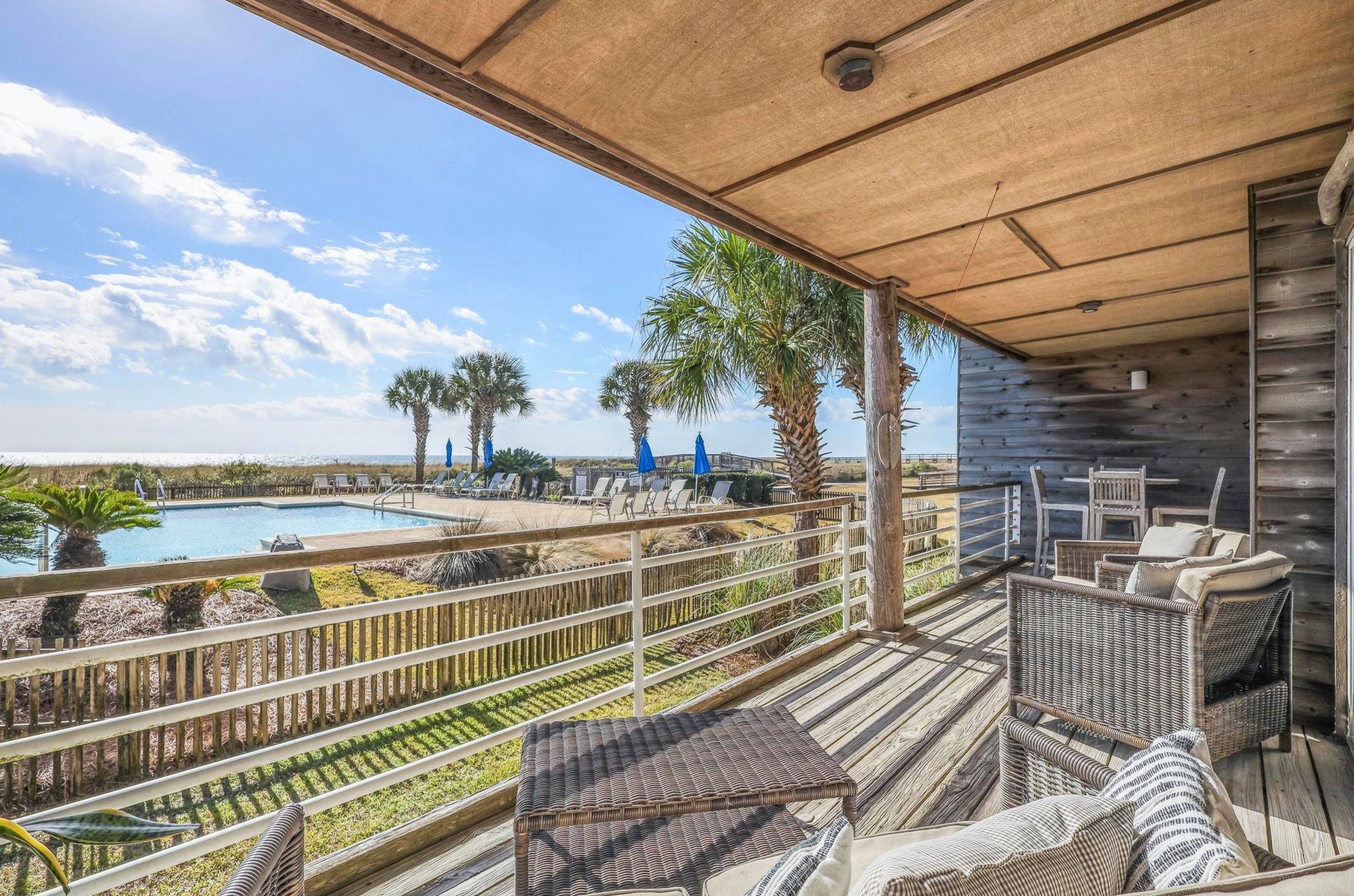 View of the Gulf and the outdoor pool from a private balcony at Needle Rush Point	