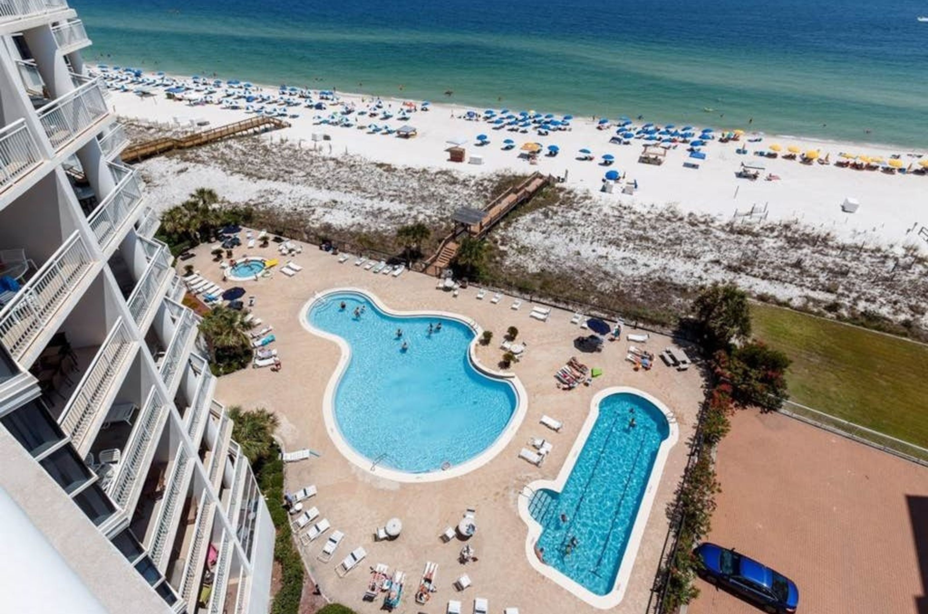 Overhead view of the pool deck with a lap pool wading pool and hot tub 