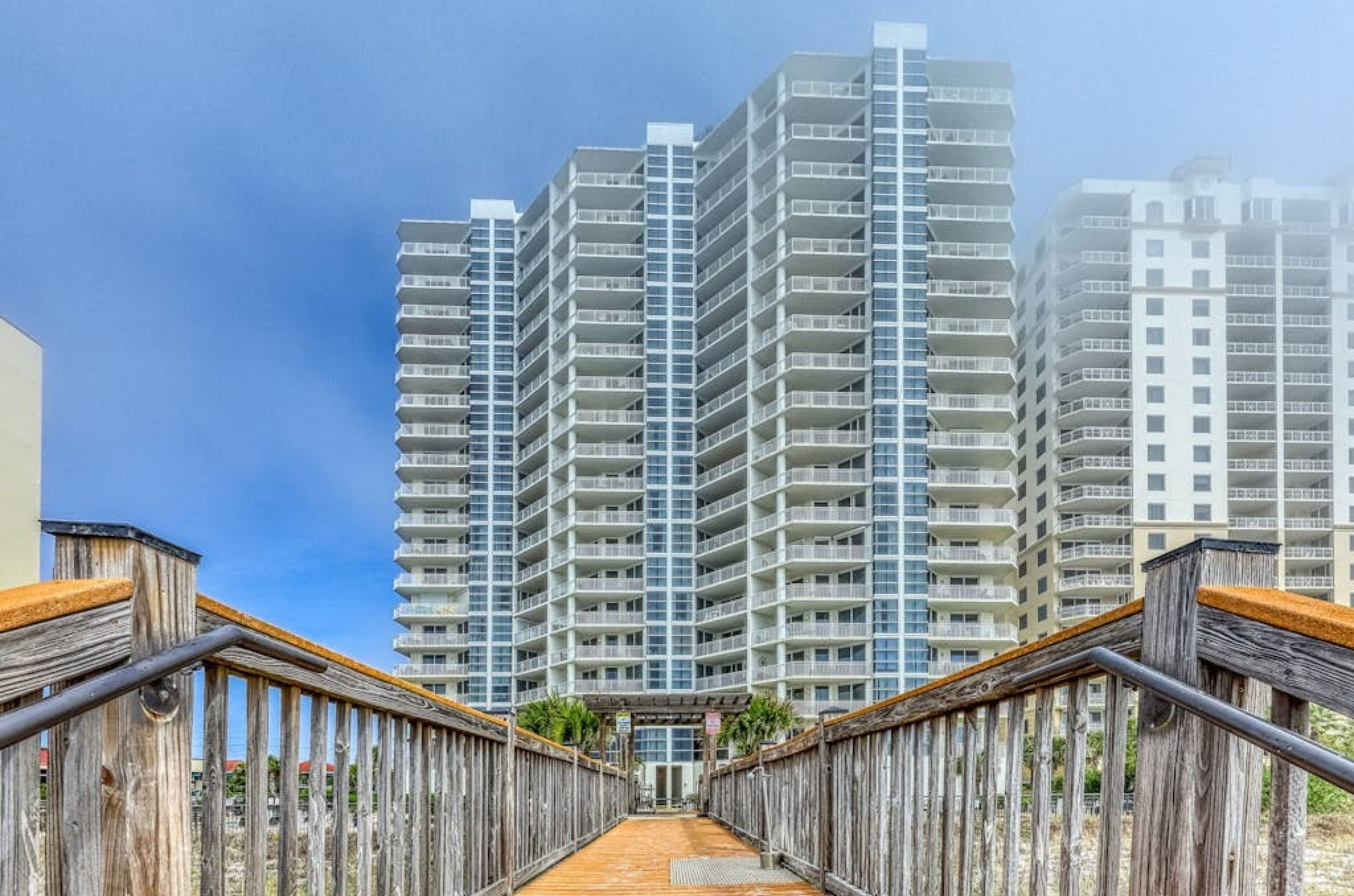 The wooden boardwalk in front of the exterior of Palacio in Perdido Key Florida 