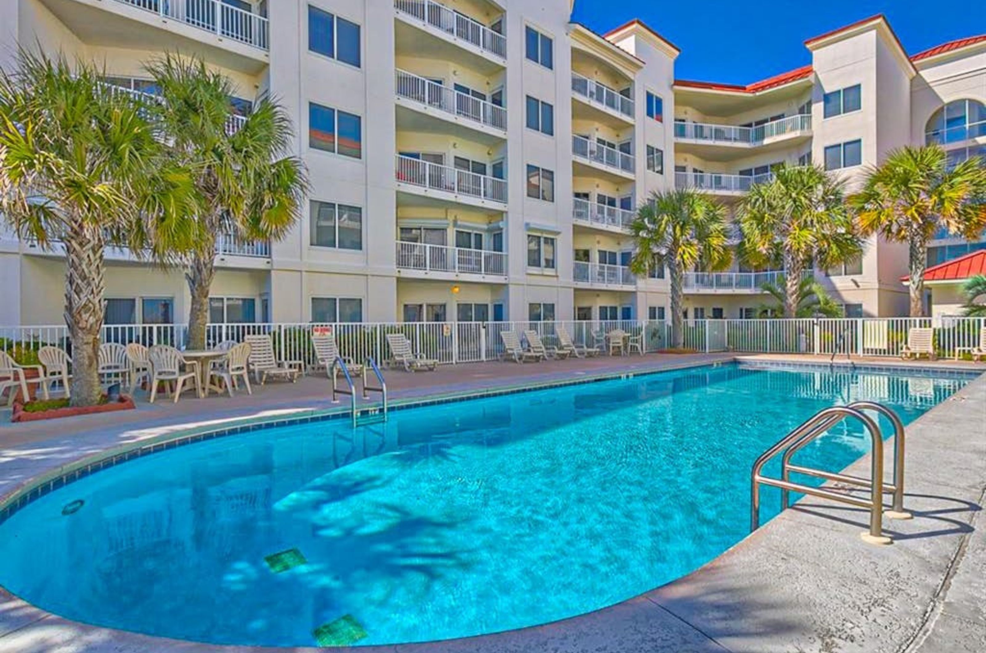The outdoor swimming pool in front of Palm Beach Condos in Orange Beach Alabama