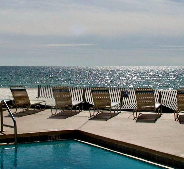 Gulf-front pool and lounge chairs at Pelican Walk Panama City