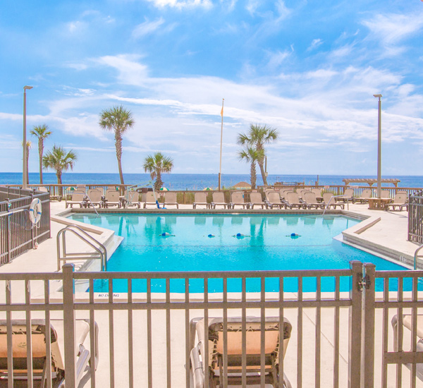 Enjoy a view of the pool and beach at Sunbird Beach Resort in Panama City Beach Florida