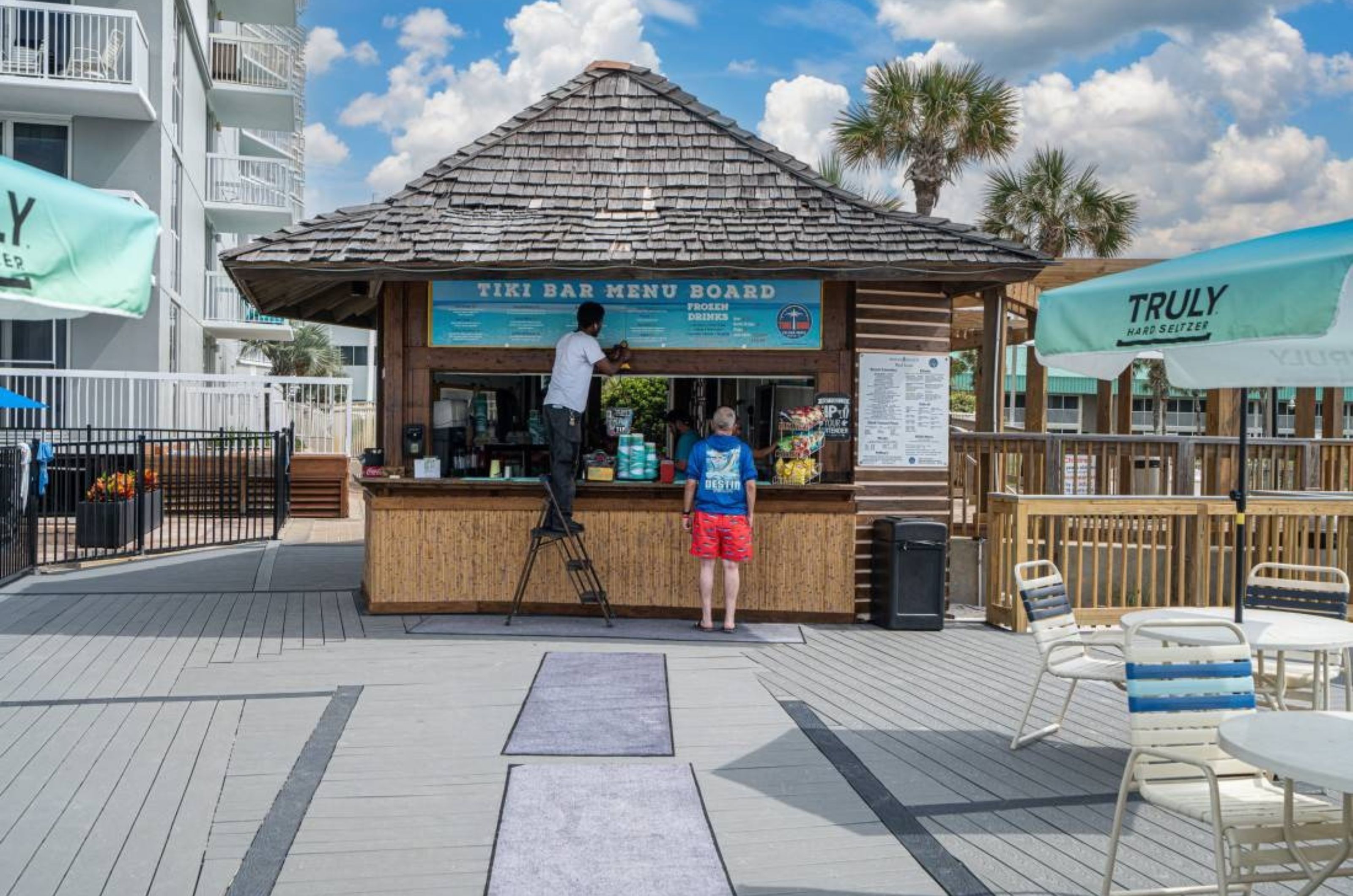 A man ordering from the poolside bar at Pelican Beach Resort in Destin Florida 