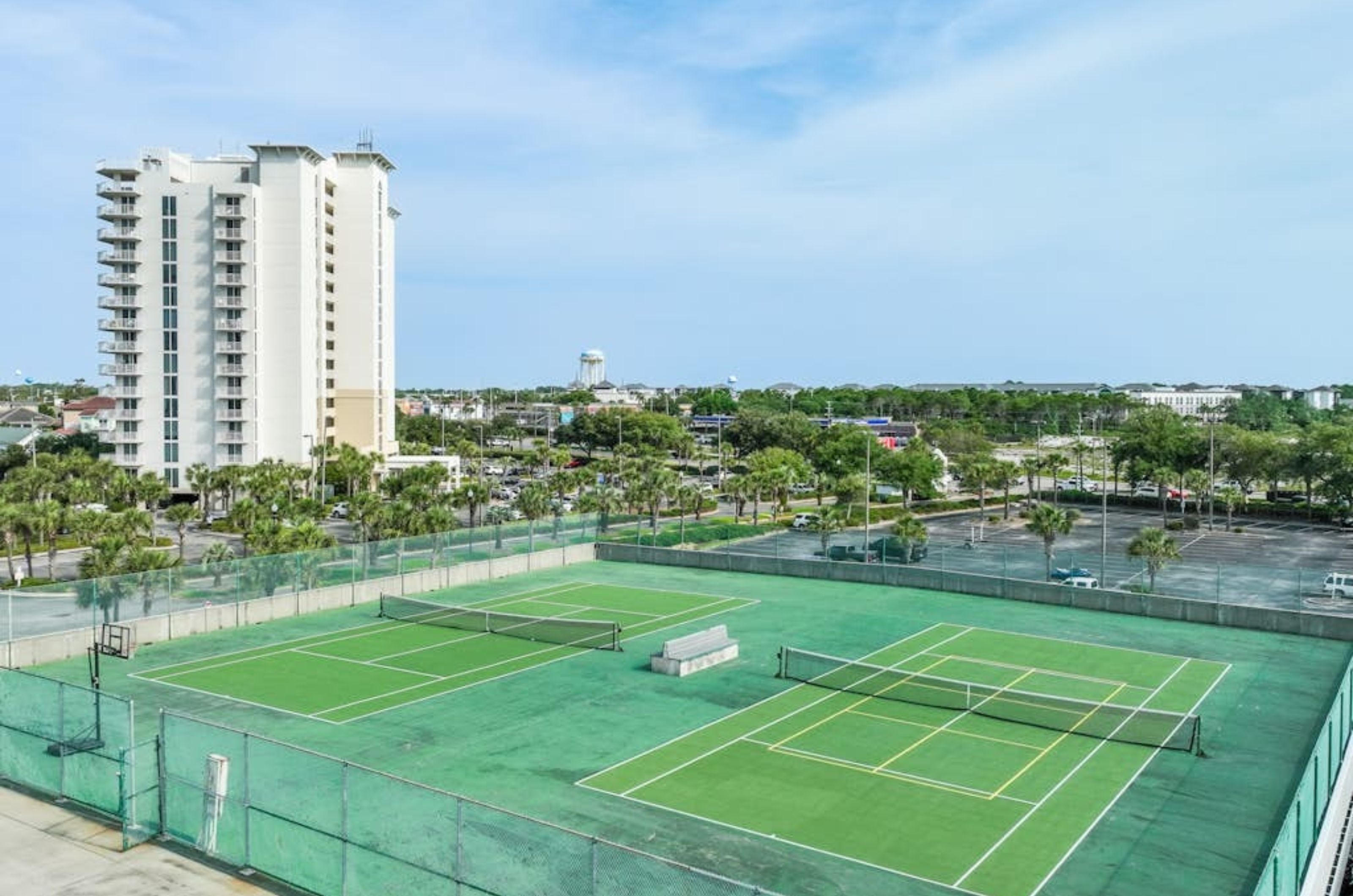 Aerial view of the green outdoor tennis courts at Pelican Beach Resort in Destin Florida 