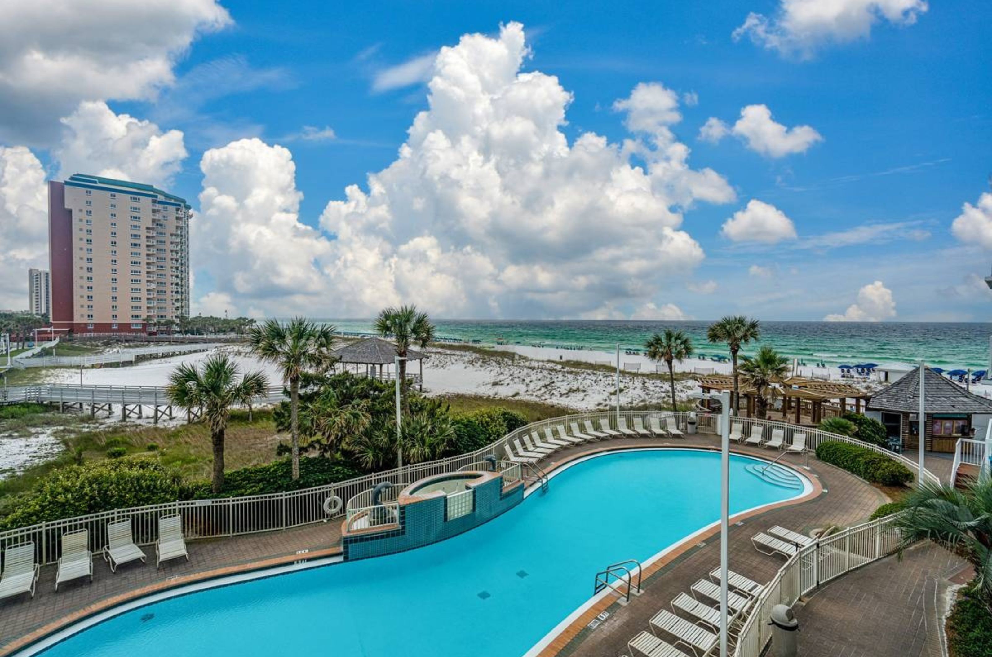 Aerial view of one of the outdoor swimming pools with lounge chairs 