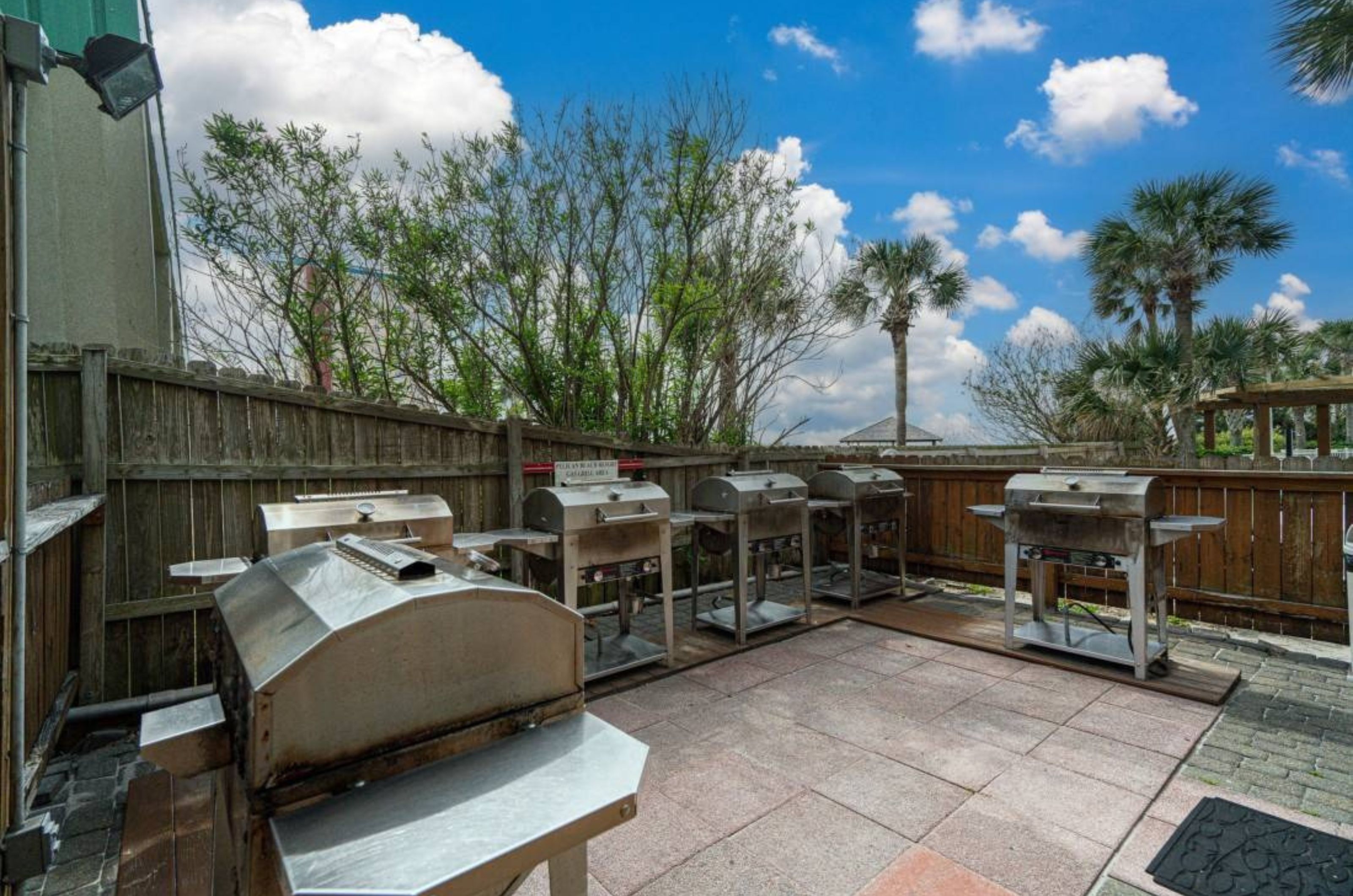 The outdoor barbecue grills surrounded by wooden fences at Pelican Beach Resort in Destin Florida 