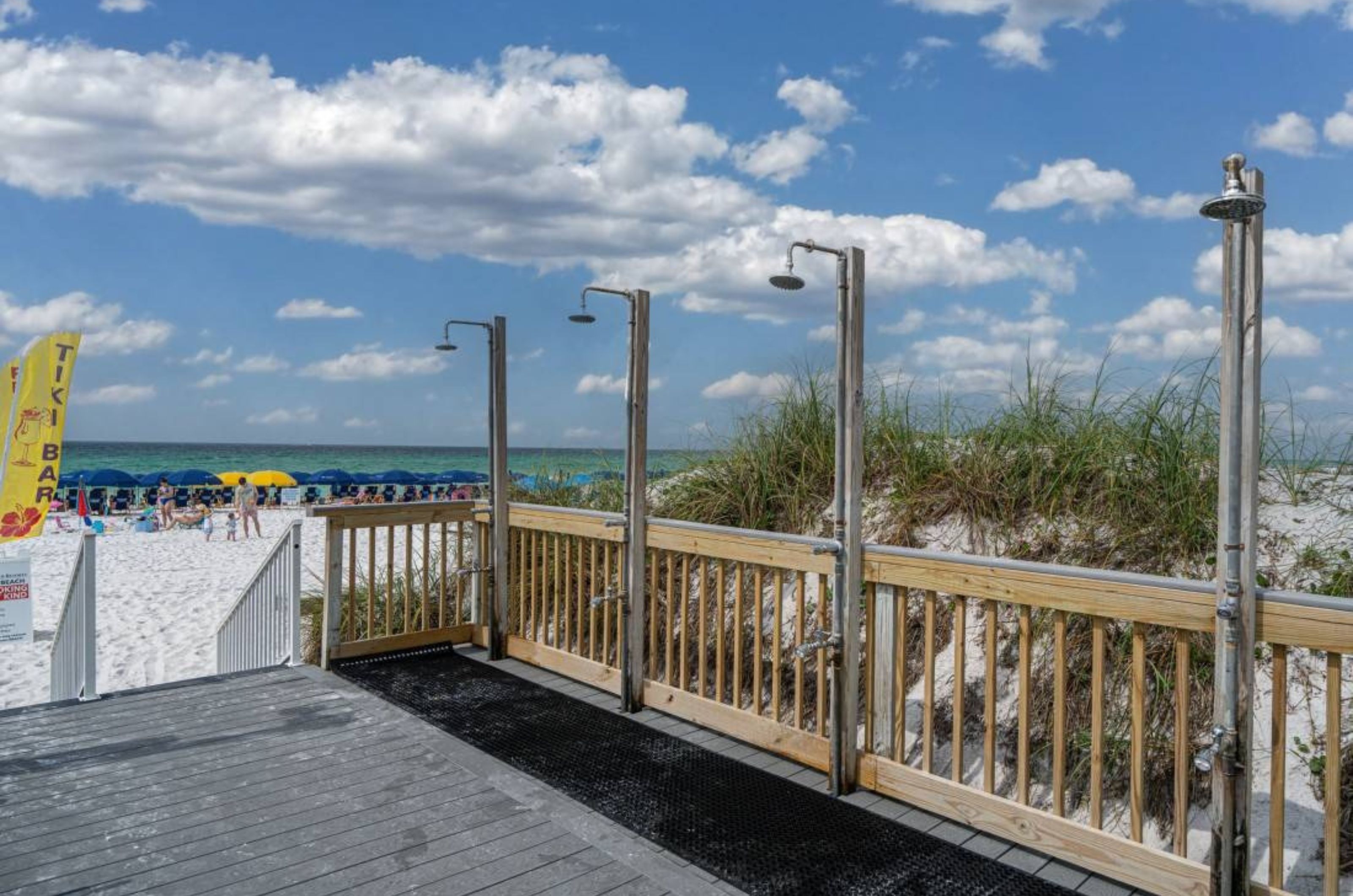 The outdoor showers on the wooden boardwalk next to the beach 