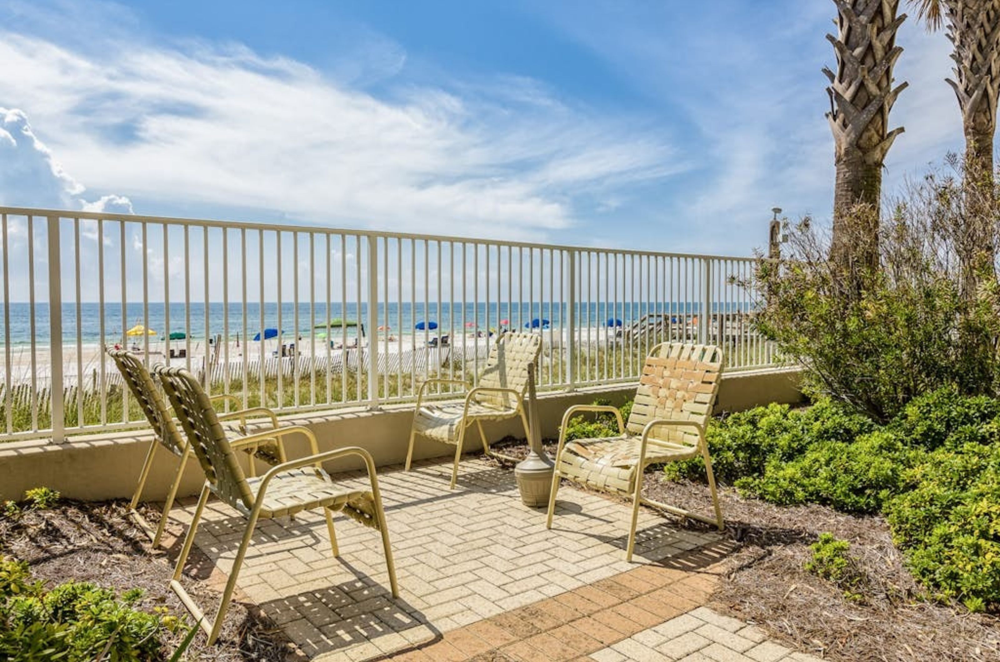 Chairs on the pool deck overlooking the beach at Pelican Pointe in Orange Beach Alabama 