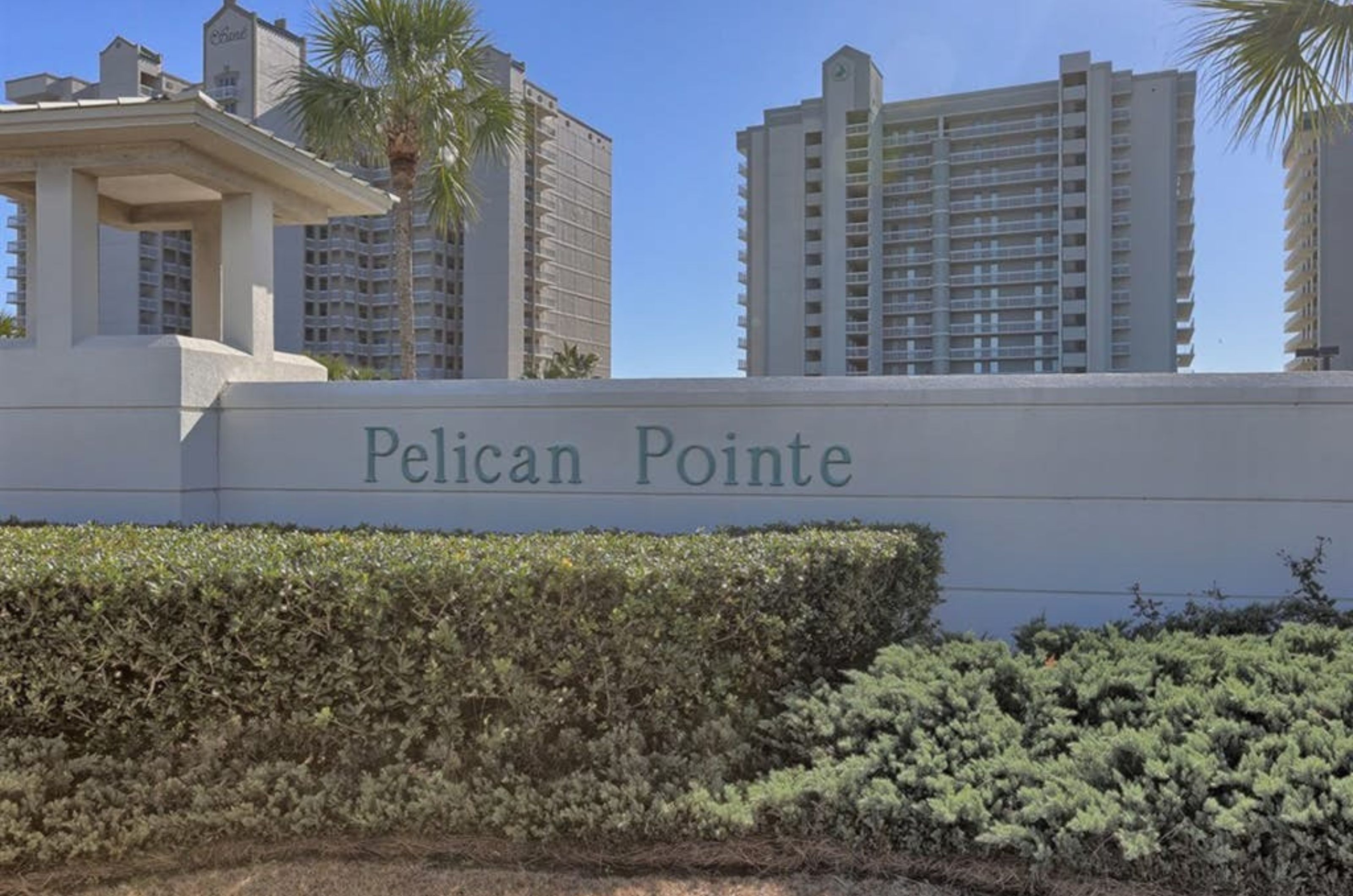 View from the street of Pelican Pointe Condominiums and the property's entry sign 