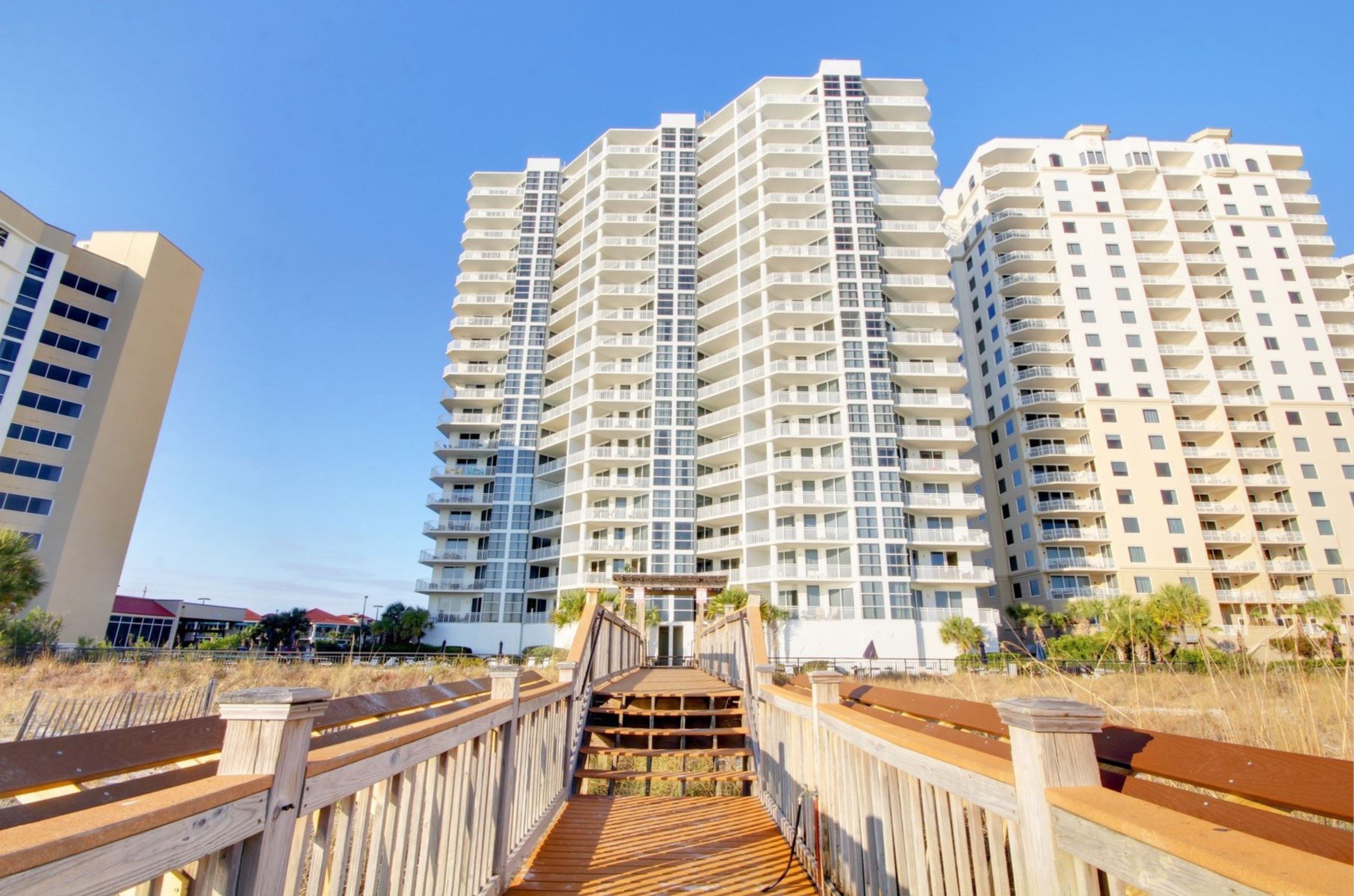 The beachside exterior of Palacio and wooden boardwalk in Perdido Key Florida