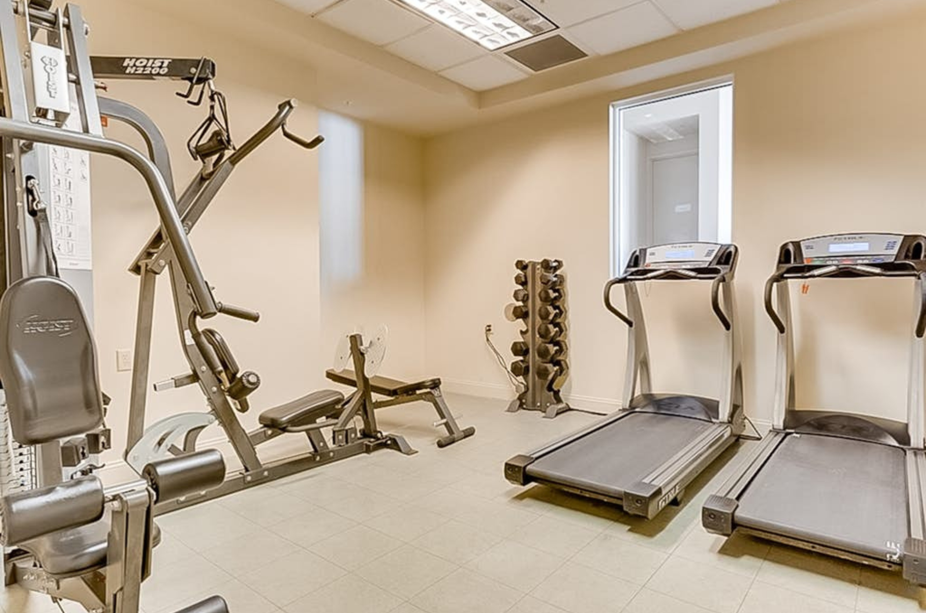 The on-site fitness center with treadmills and strength equipment at Perdido Sun in Perdido Key Florida	