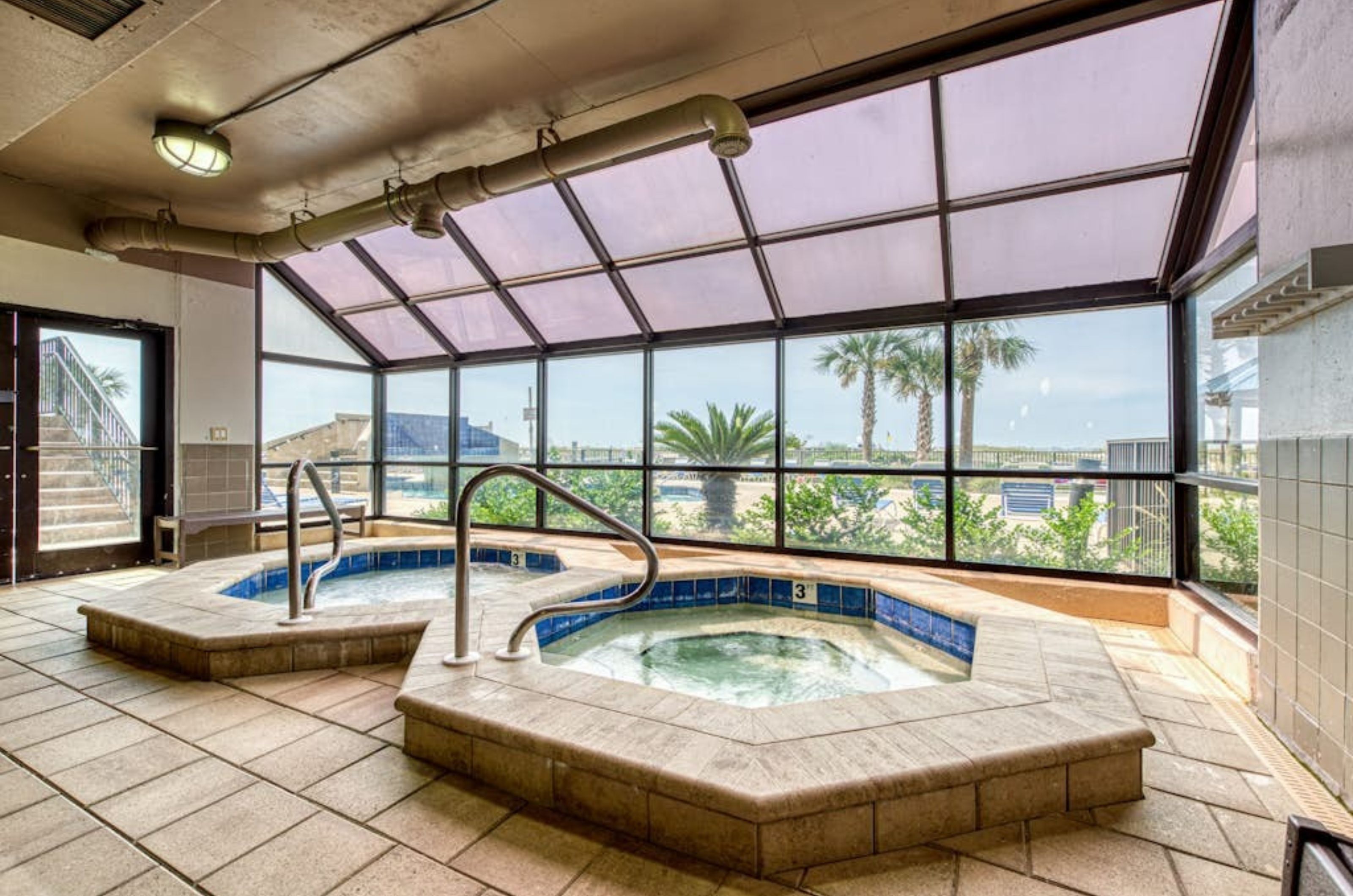 The indoor hot tubs next to windows at Phoenix II in Orange Beach Alabama 