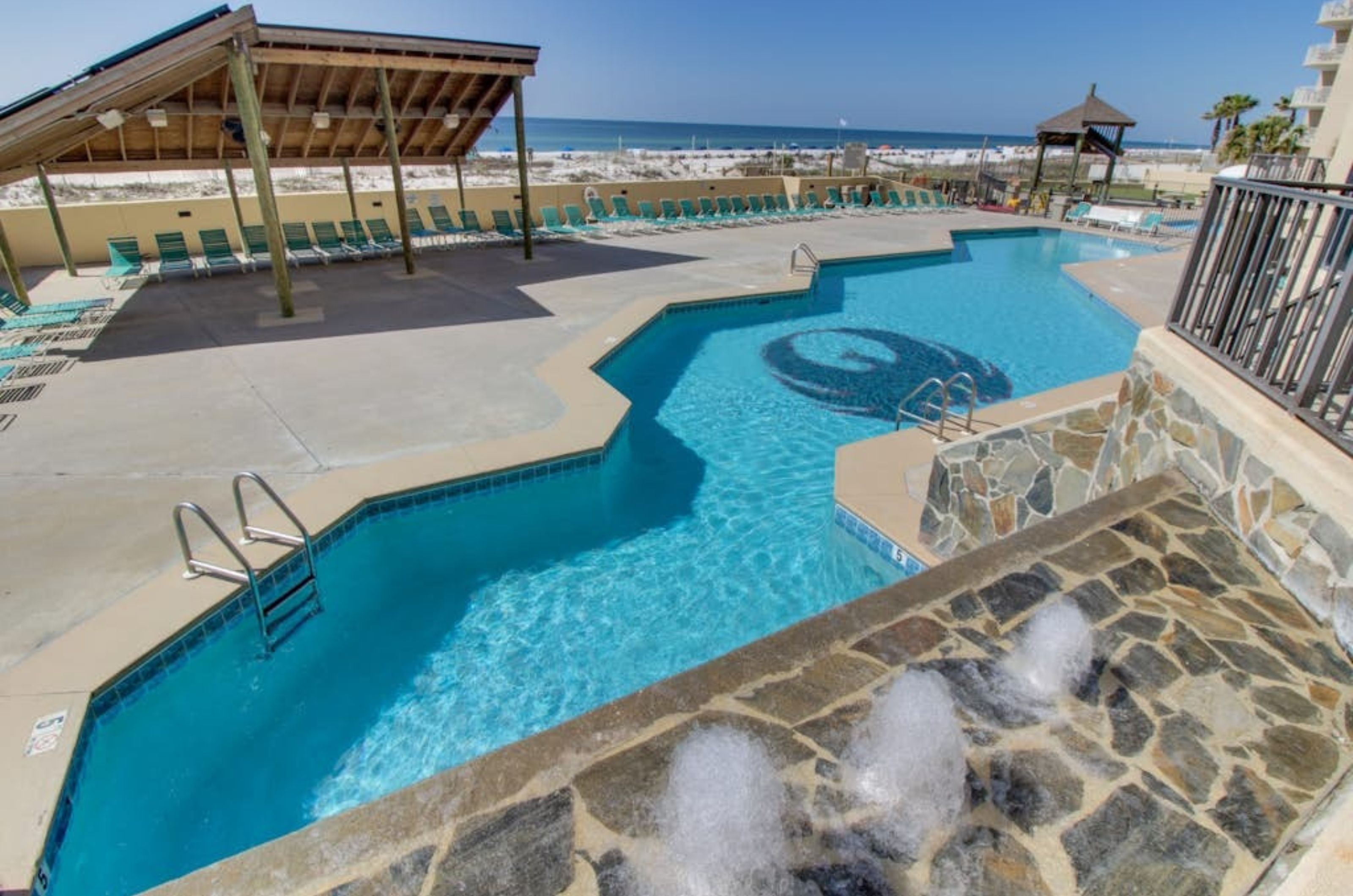 Overhead view of the long outdoor swimming pool at Phoenix I in Orange Beach Alabama 