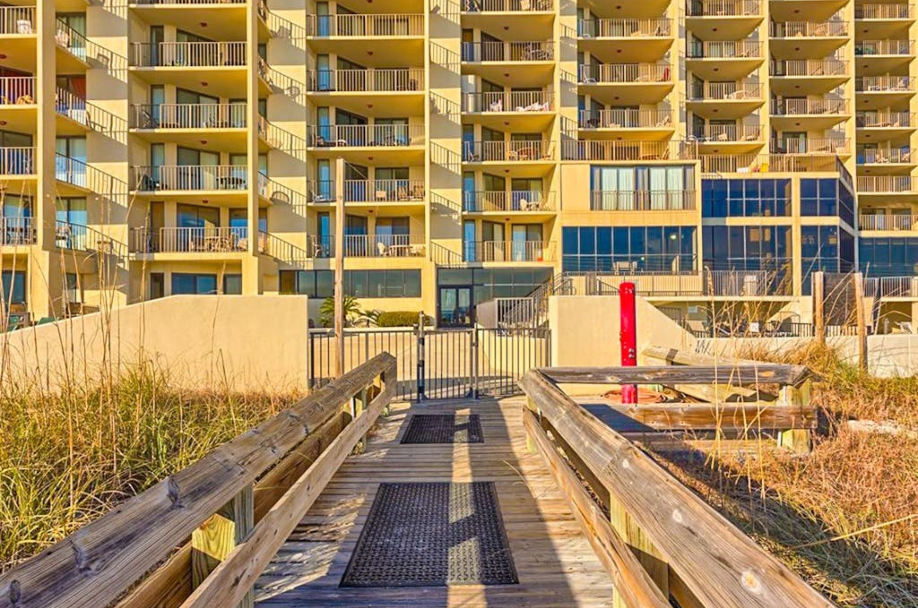 View from the beach of the pool deck and the exterior of Phoenix III in Orange Beach Alabama 
