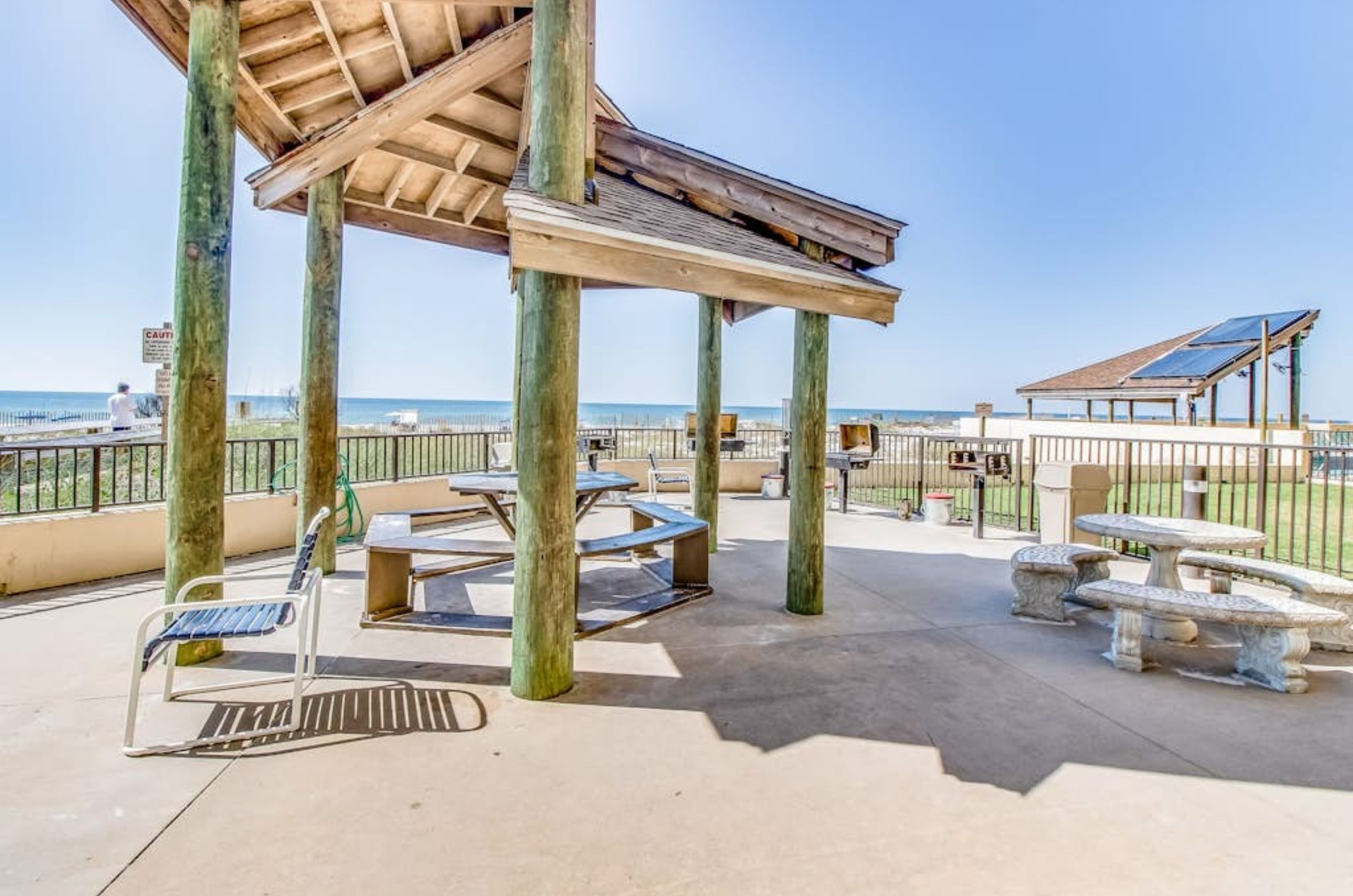 The oudoor barbecue grills next to the picnic tables under a gazebo at Phoenix III 