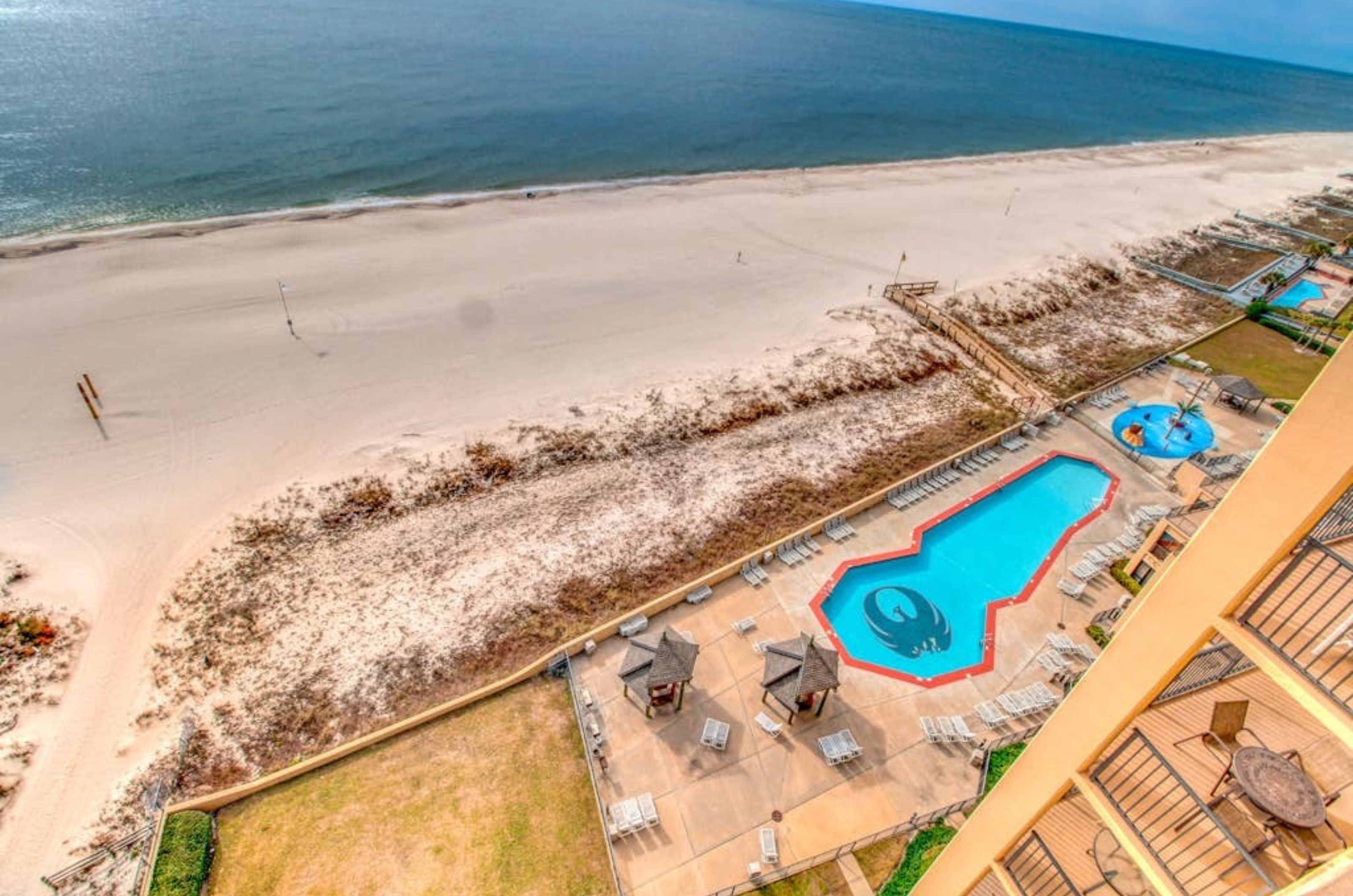 Overhead view of the beachside pool and pool deck at Phoenix V in Orange Beach Alabama 