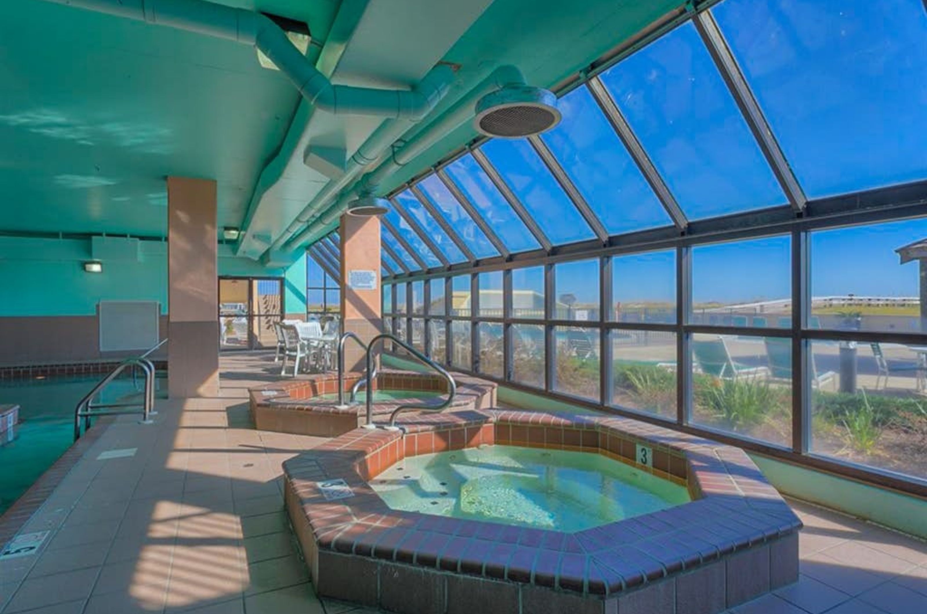 The indoor hot tubs next to windows at Phoenix VII in Orange Beach Alabama 