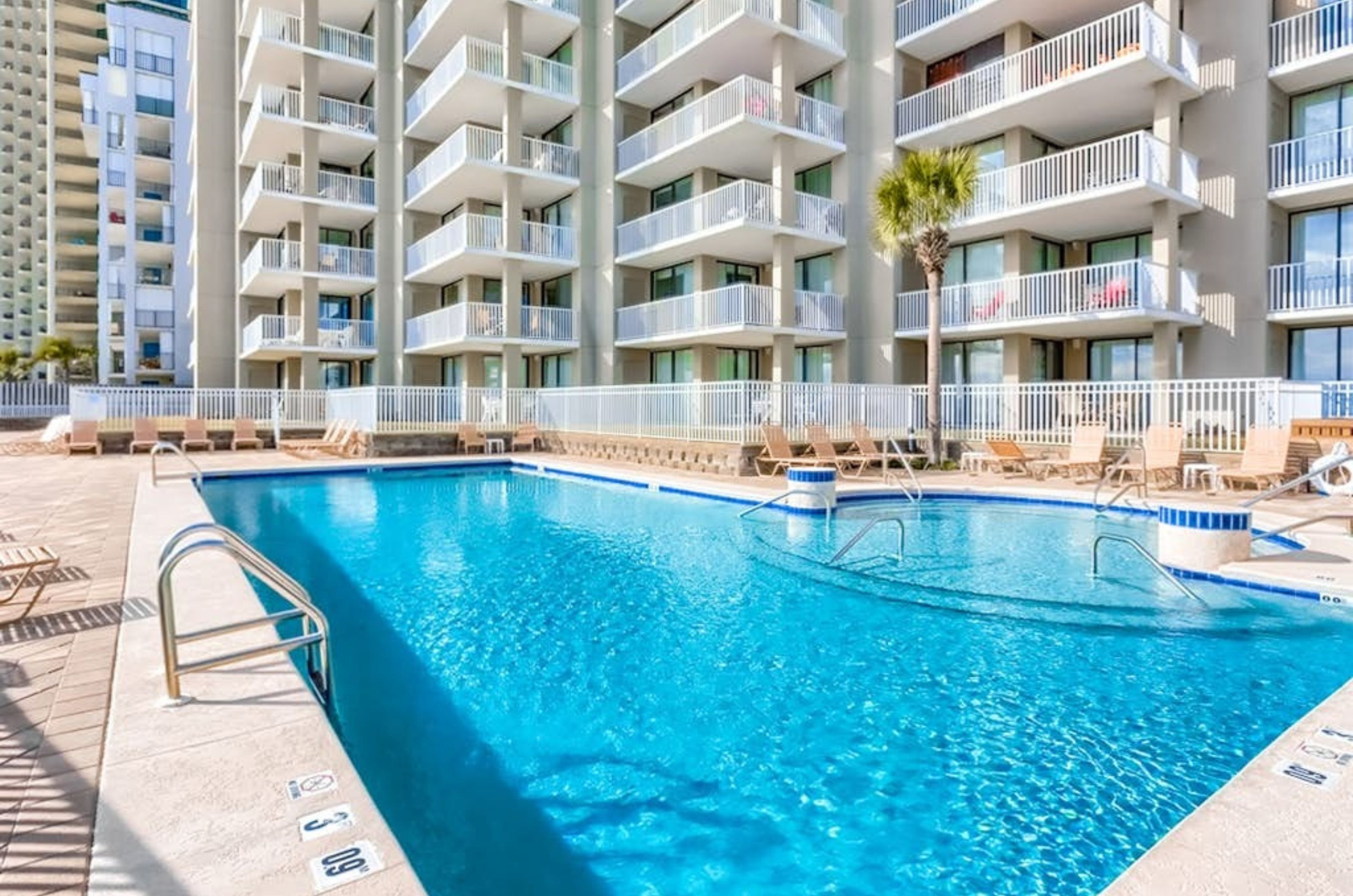 The outdoor swimming pool in front of Romar Place in Orange Beach Alabama