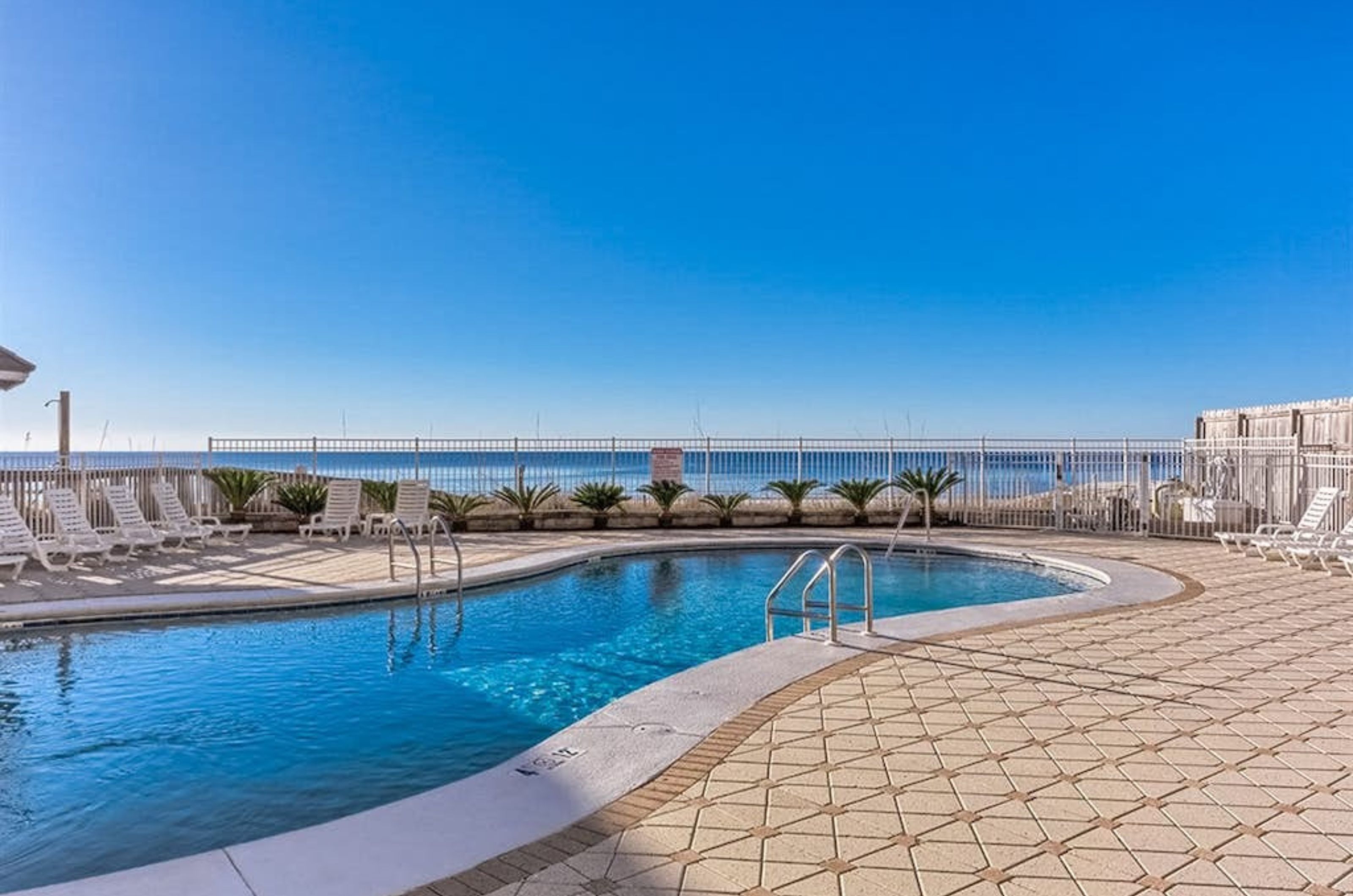 The spacious pool and pool deck at Romar Tower