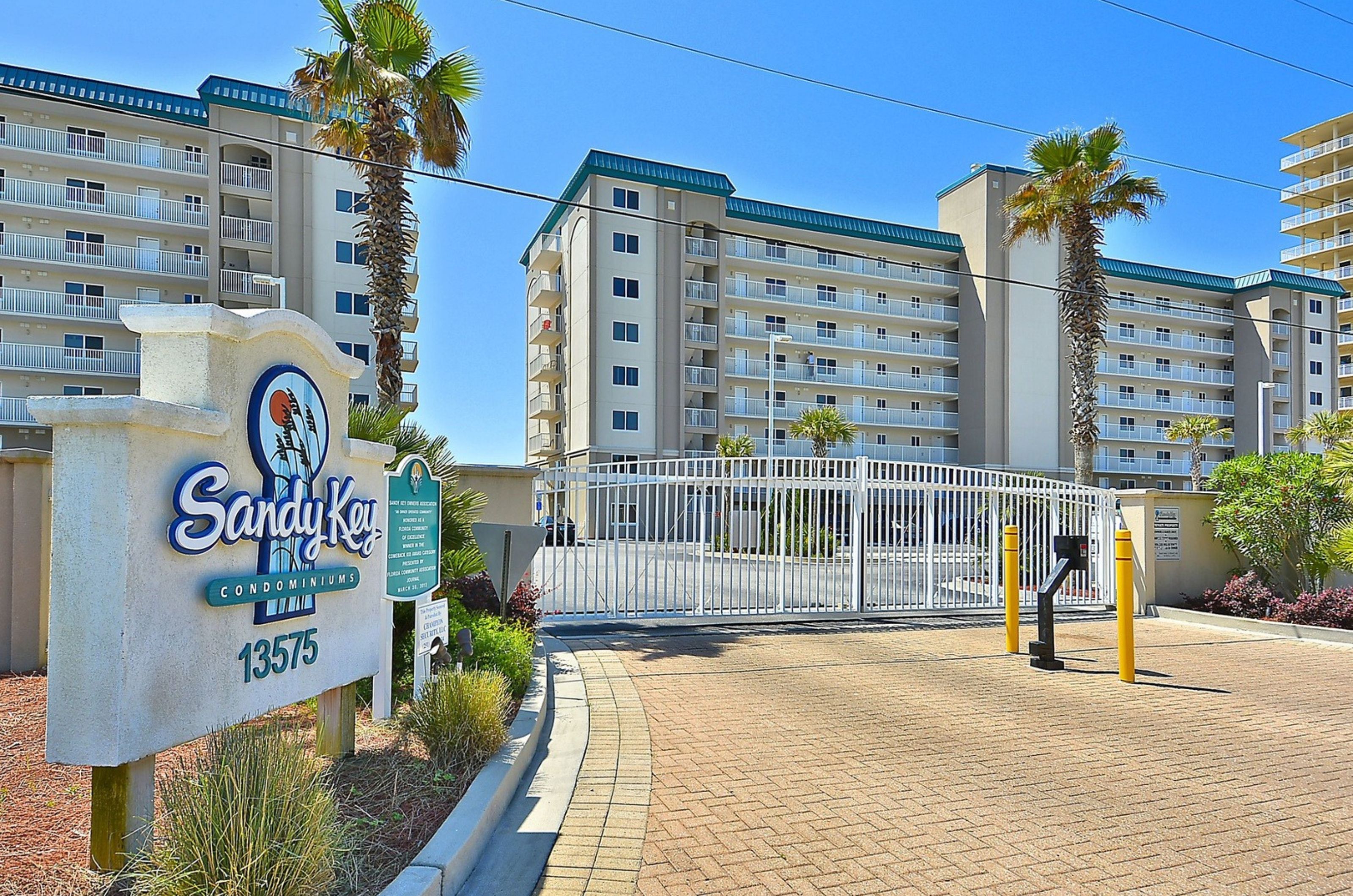 View of the entry gate and sign at Sandy Key Condominiums in Perdido Key Florida 