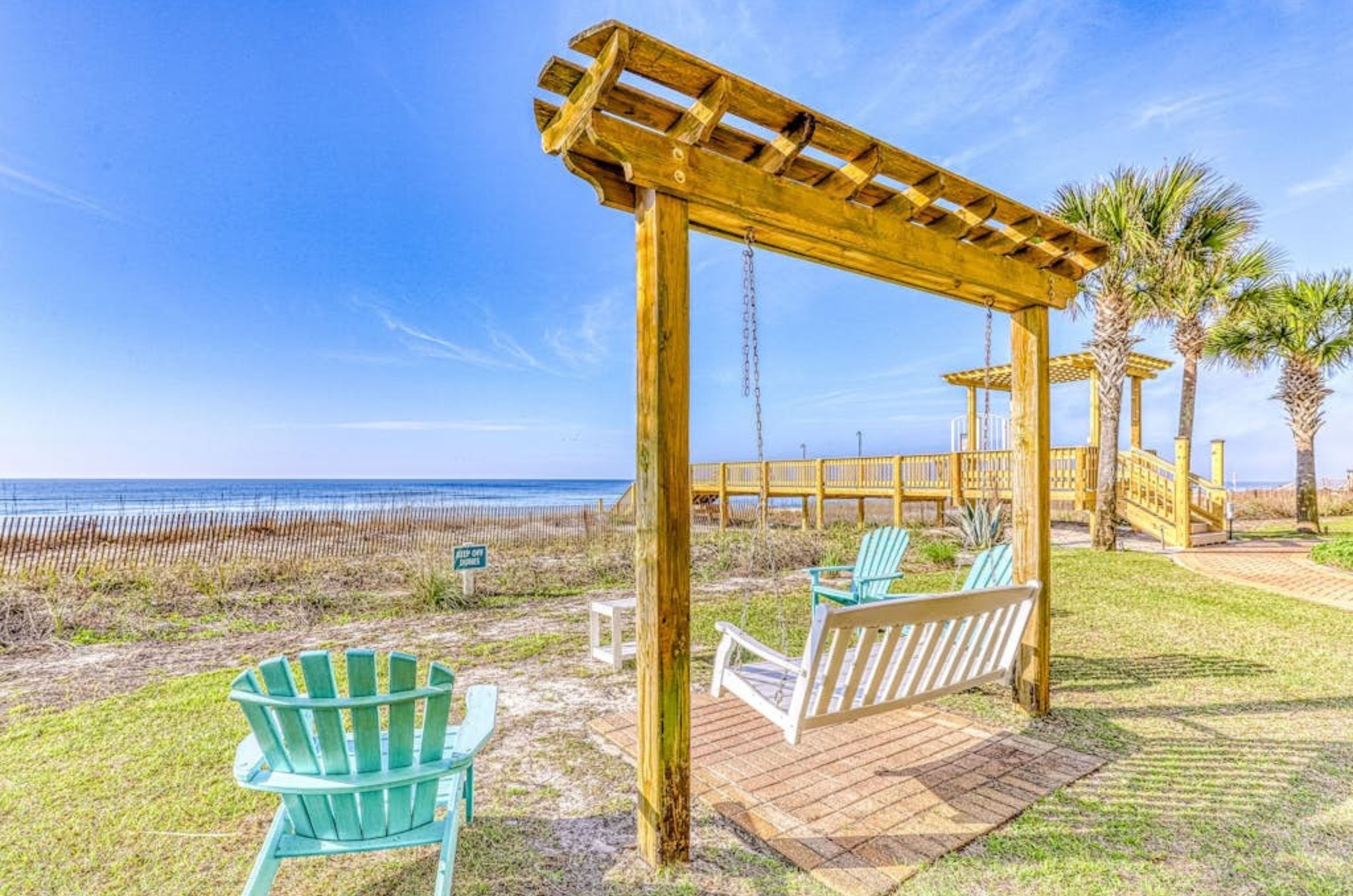 	Wooden swings and chairs overlooking the beach at Sandy Key Condos in Perdio Key Florida	