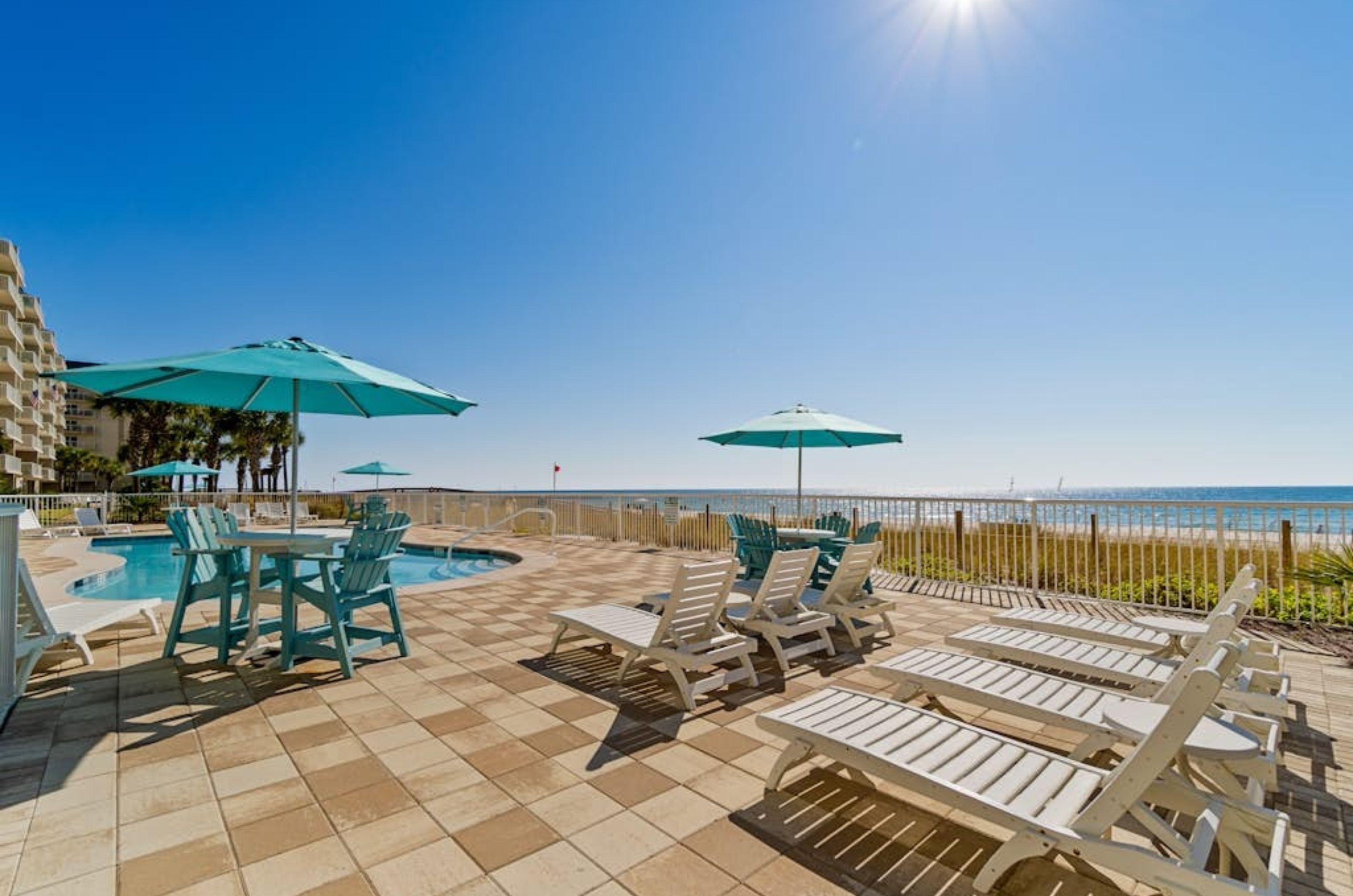 Lounge chairs on the beachside pool deck at Sandy Key Condominiums in Perdido Key Florida 