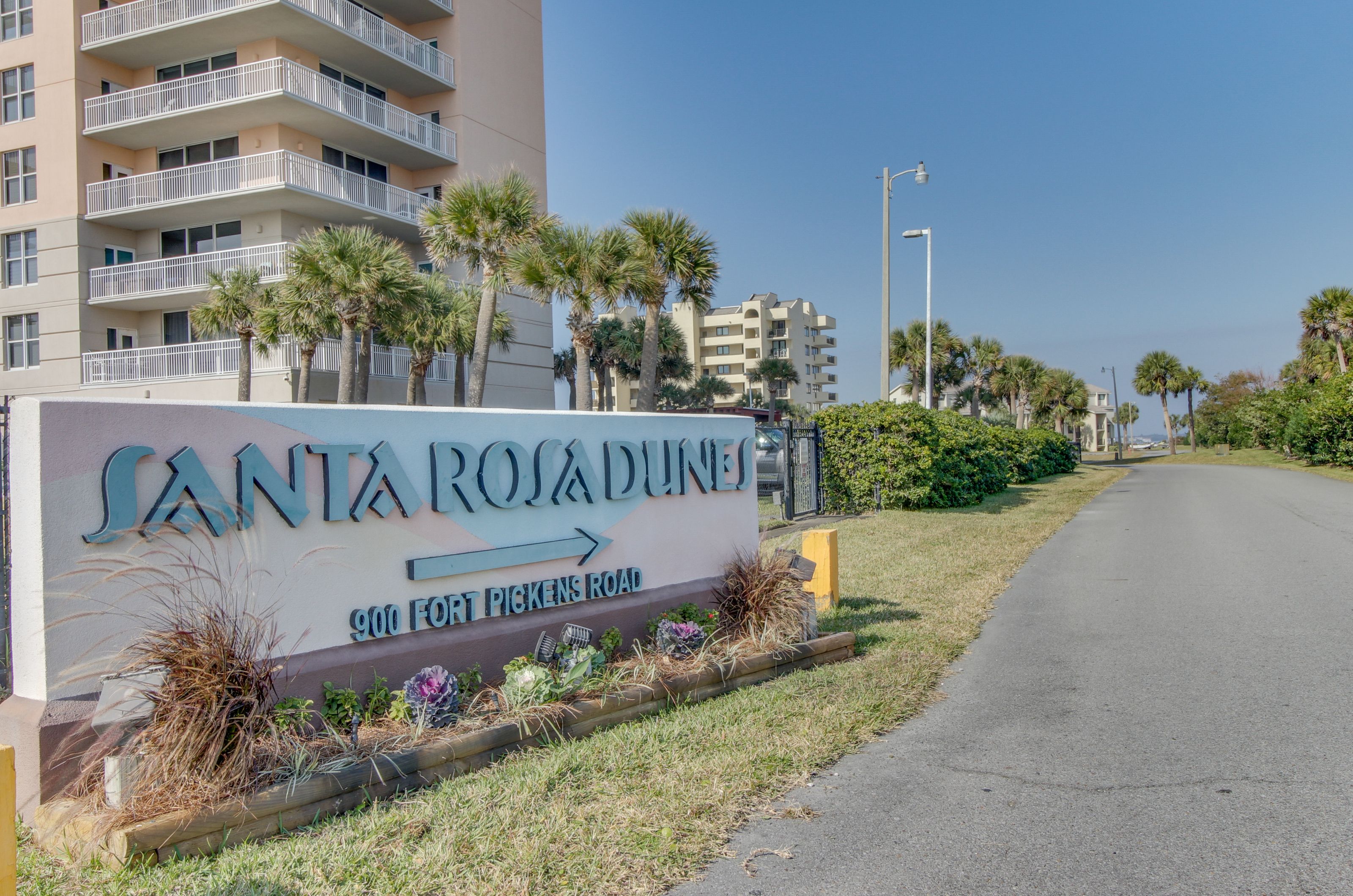 The road leading to Santa Rosa Dunes with the property's entry sign 