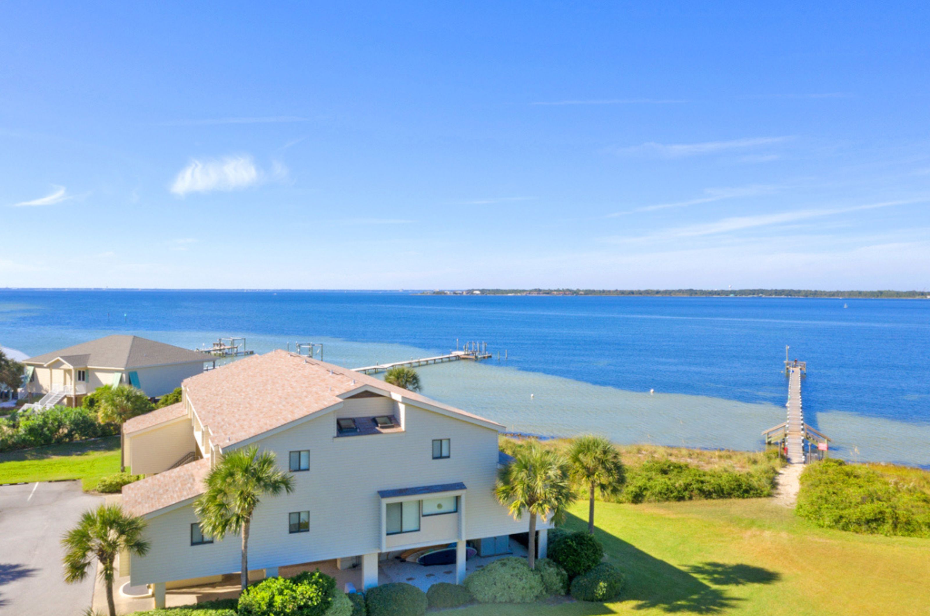 View from the sky of a townhome next to the water 