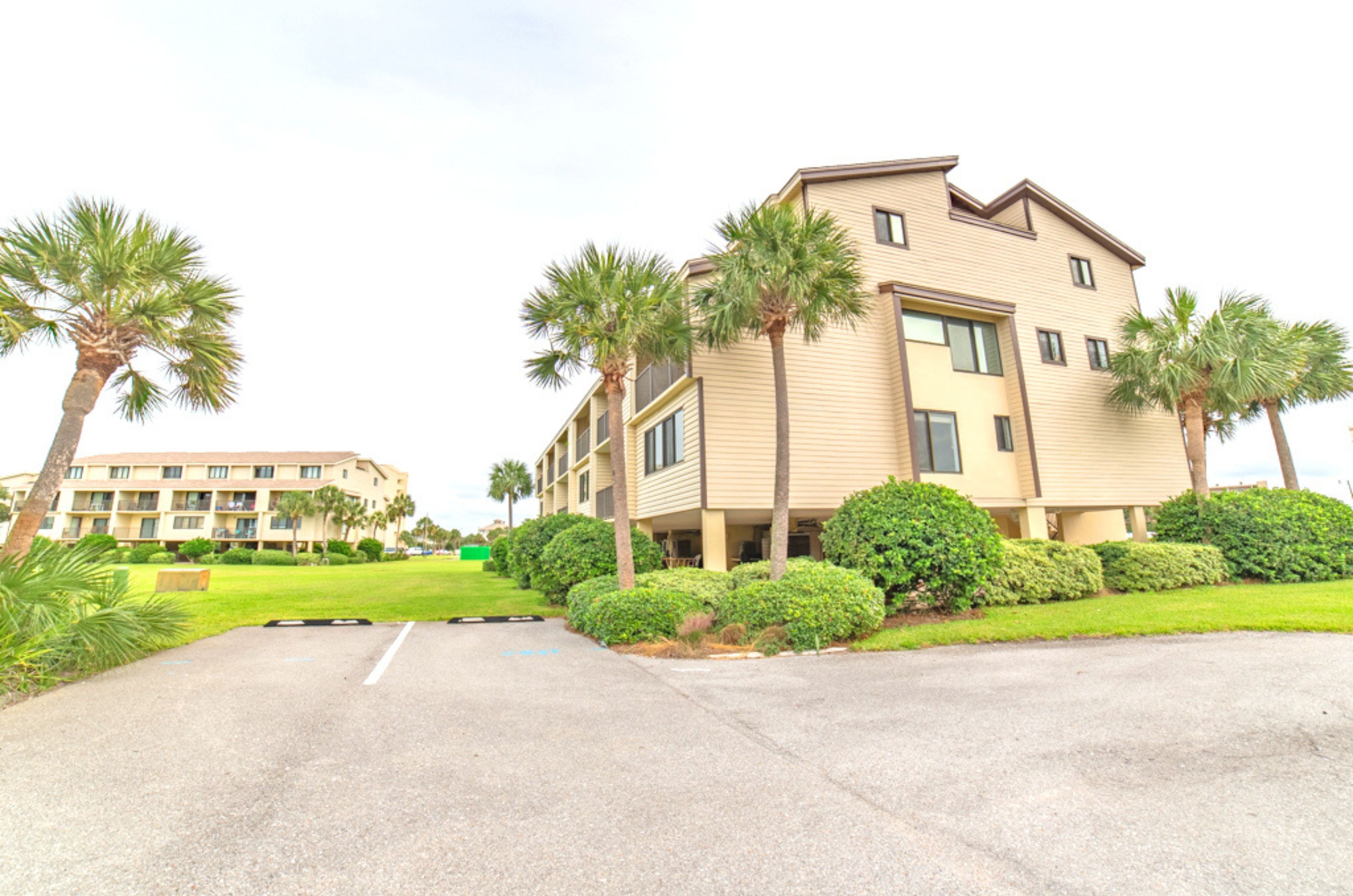 View from the street of two parking spaces and one townhome at Santa Rosa Dunes in Pensacola Beach Florida 