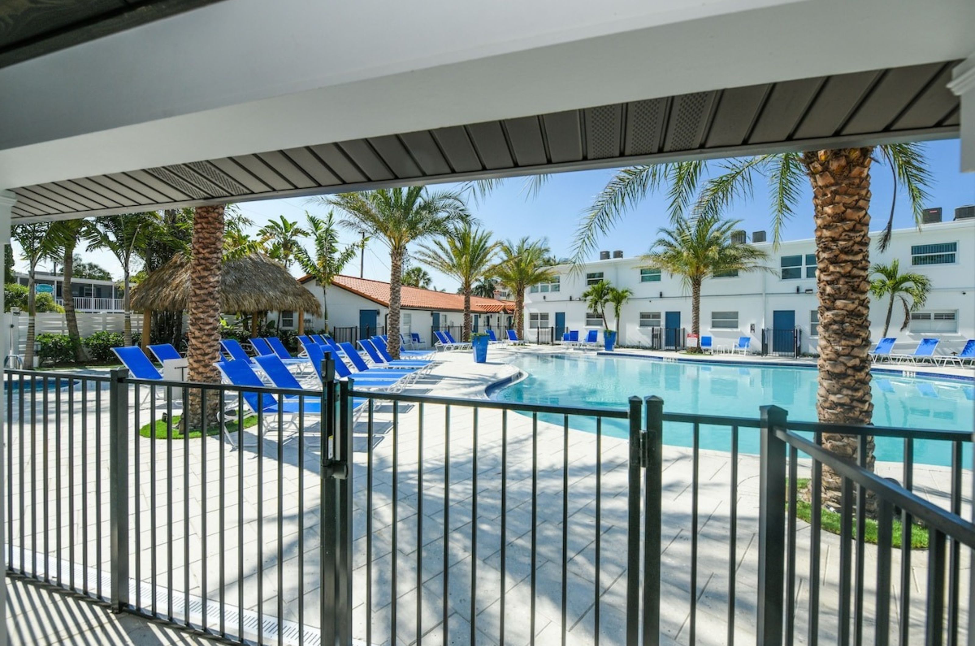 The spacious outdoor pool and pool deck at Siesta Key Beach Resort and Suites 