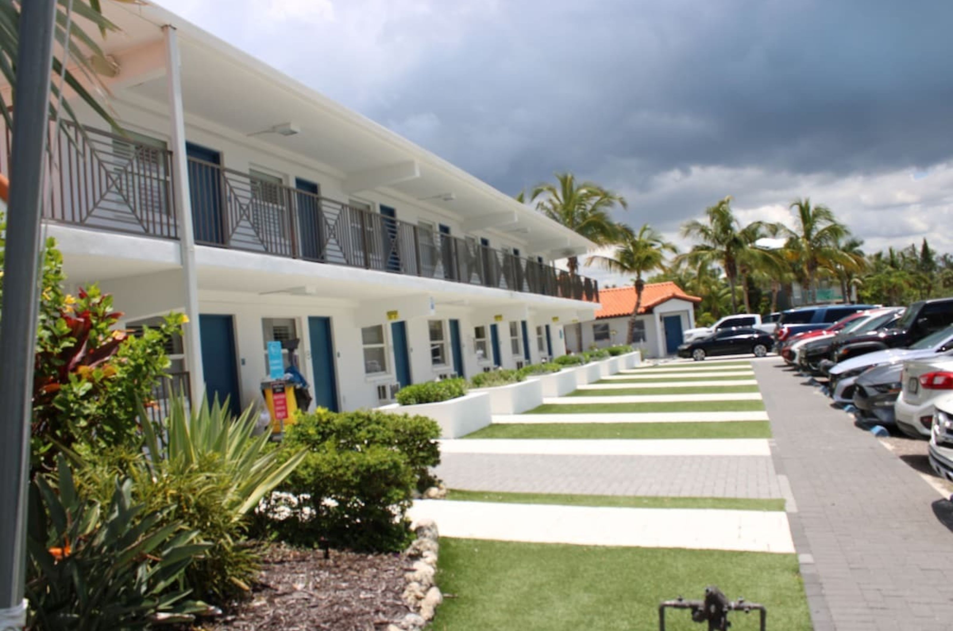 The exterior of Siesta Key Beach Resort and Suites with complimentary parking spots in front 