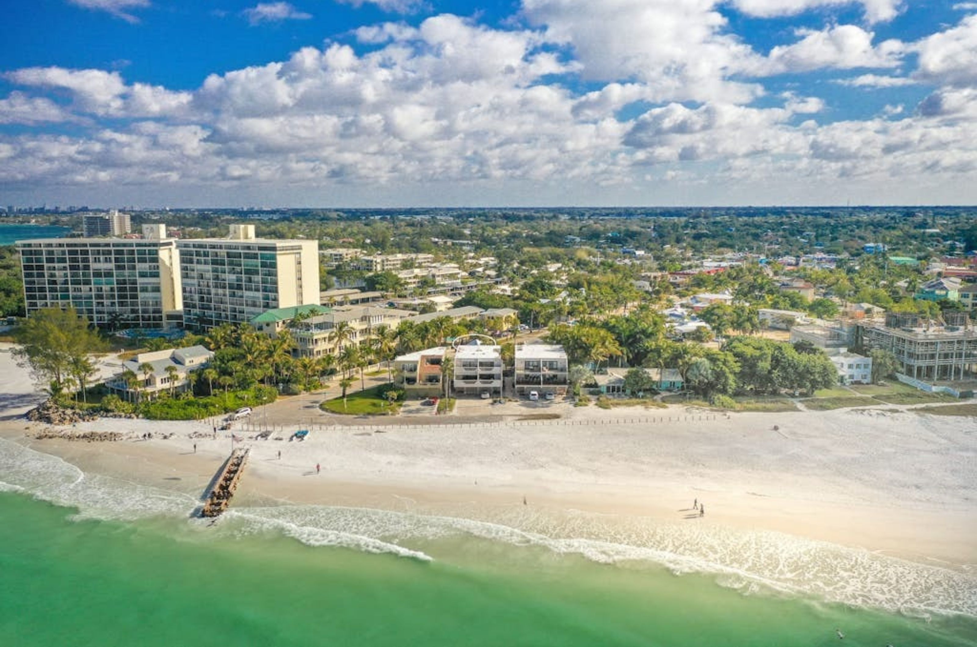 Bird's eye view from the ocean of the beach and the green inland with rental homes in Siesta Key Florida 