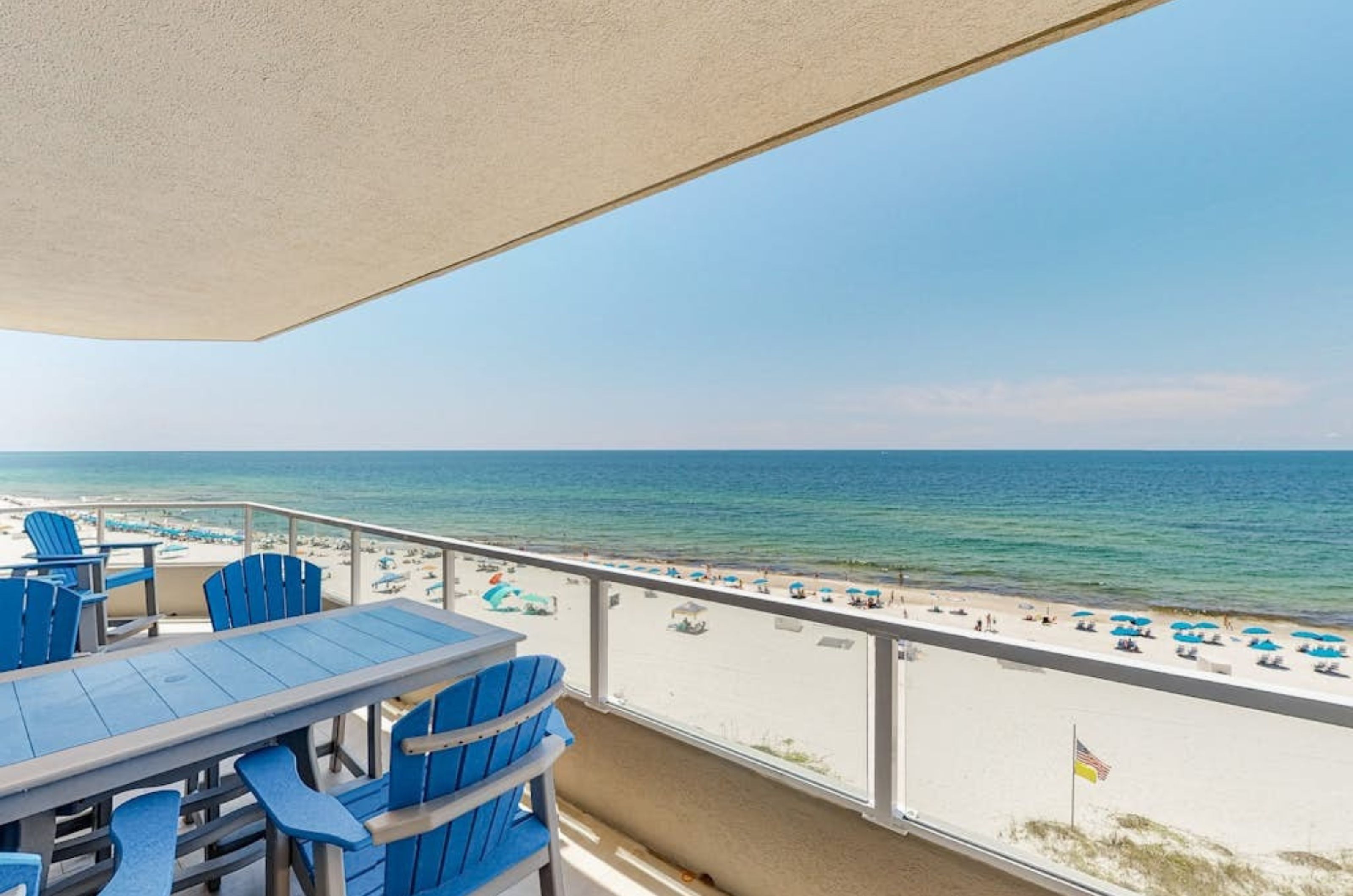 A private balcony with chairs and a table overlooking the beach at Silver Beach	