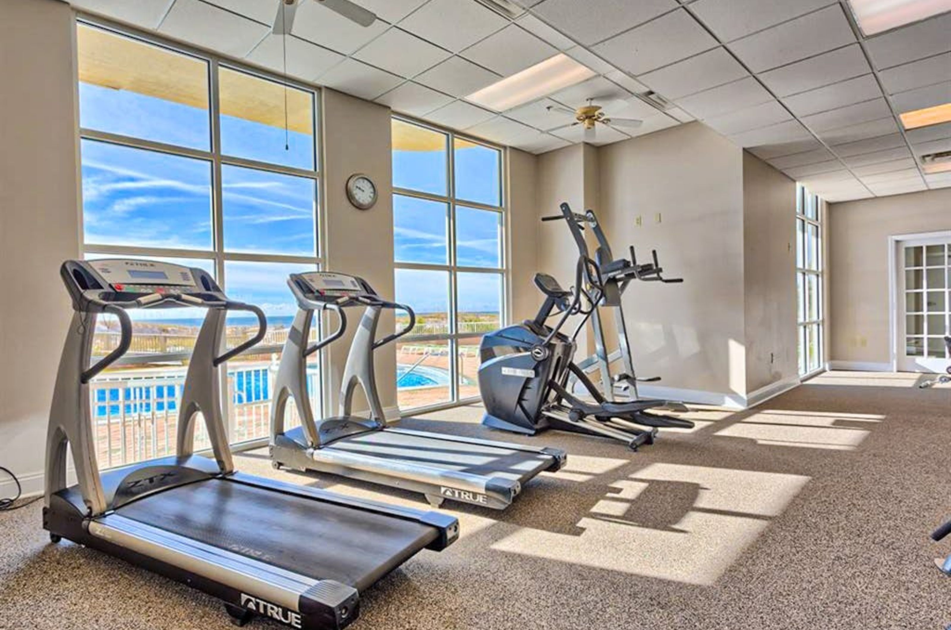 The well-equipped fitness center with strength and cardio equipment overlooking the Gulf 