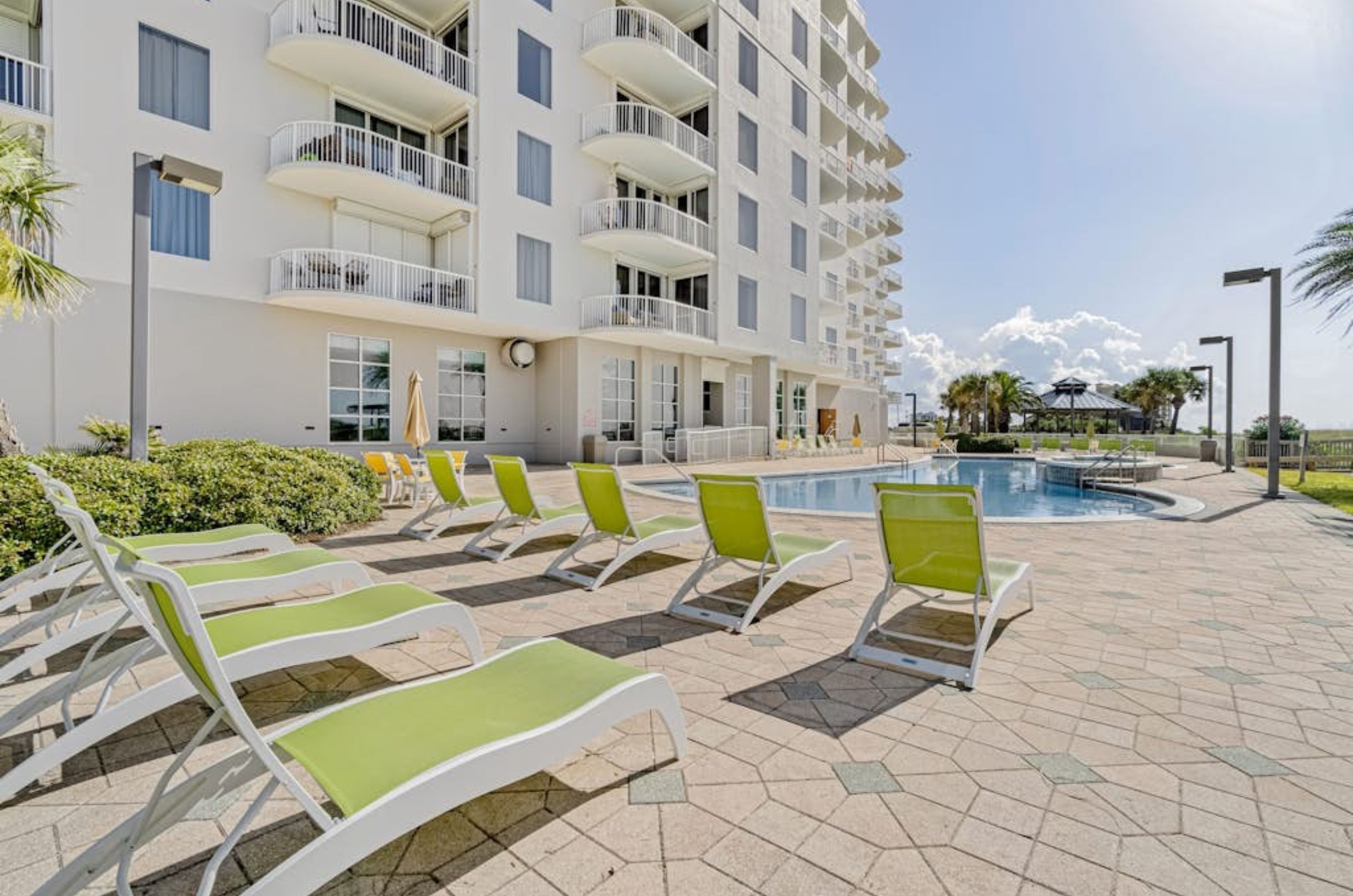 Lounge chairs on the Gulf-front pool deck by the outdoor swimming pool at Spanish Key 