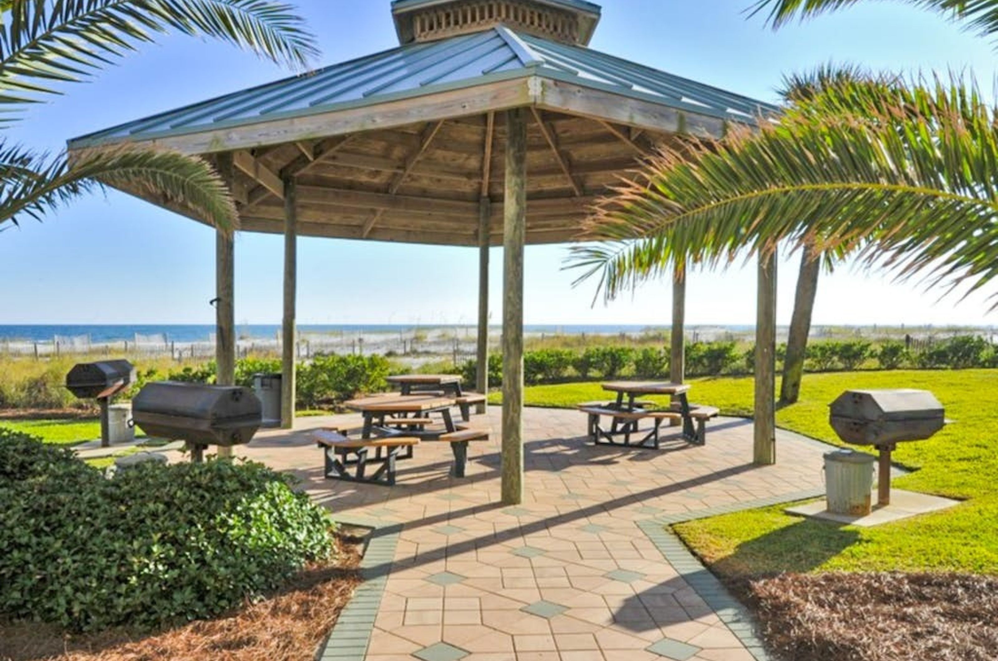 One of the gazebos at Spanish Key Condominiums with picnic tables and barbecue grills