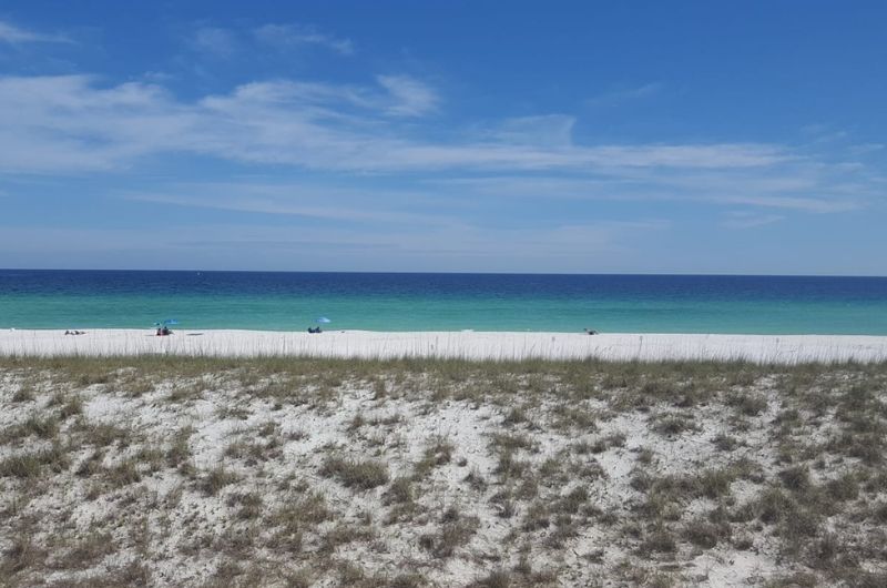 The white sandy beach and emerald waters of the Gulf of Mexico are only steps away