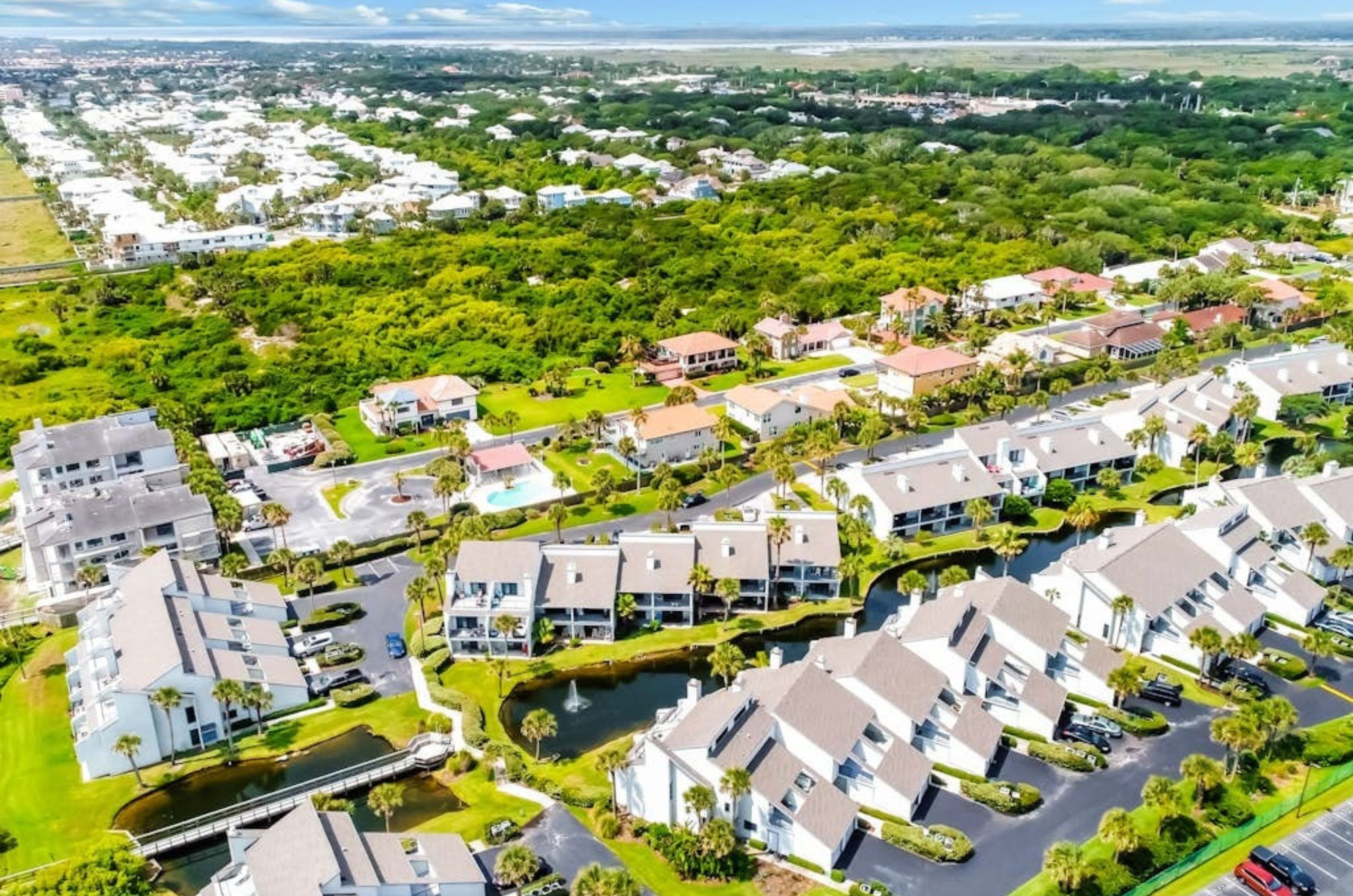 Aerial view of townhomes and condominiums amidst the green terrain of St. Augustine Florida 