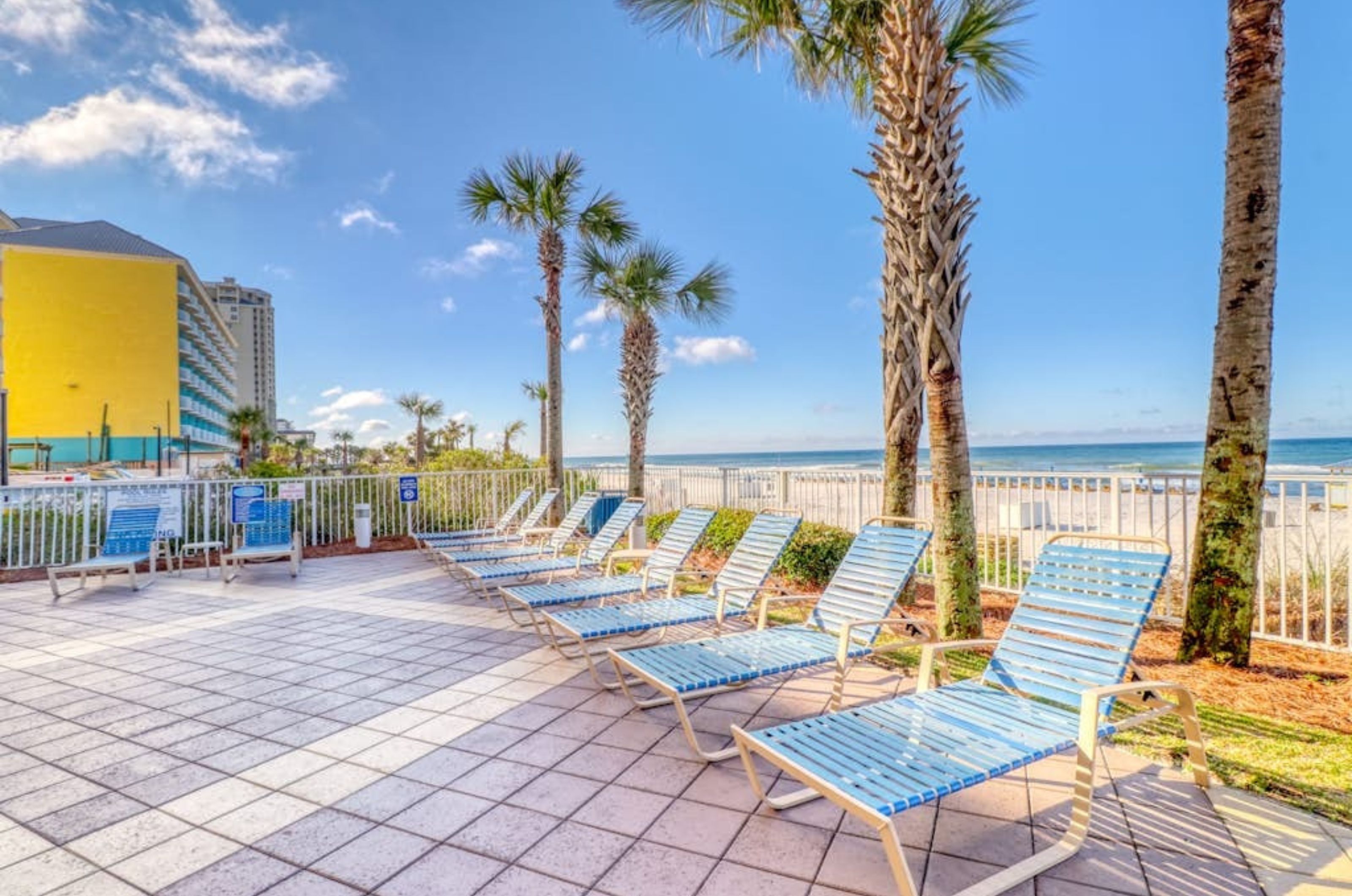 Lounge chairs on the beachside pool deck at Sterling Reef in Panama City Beach Florida 