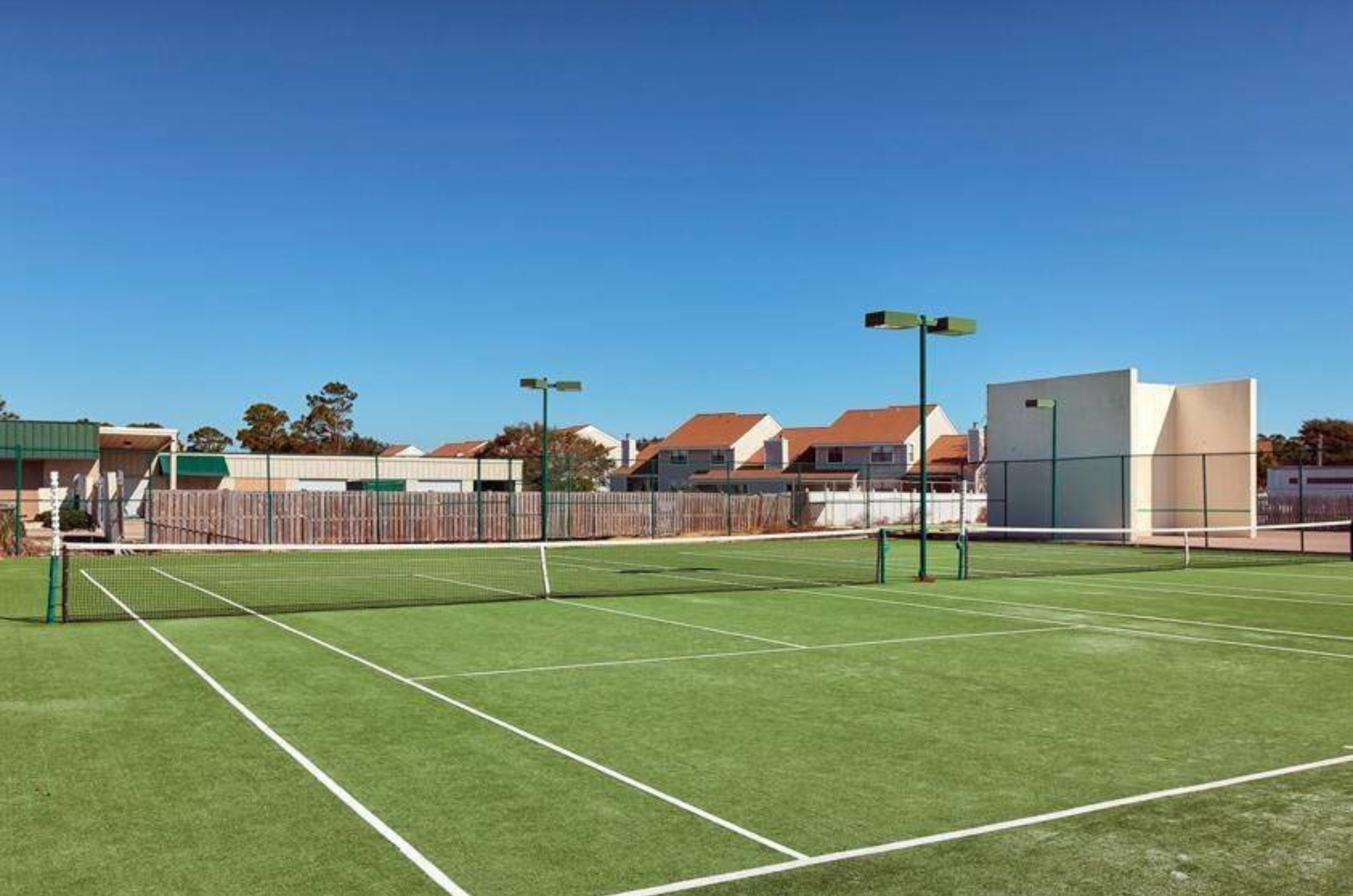 The outdoor tennis court at Summer House on Romar Beach