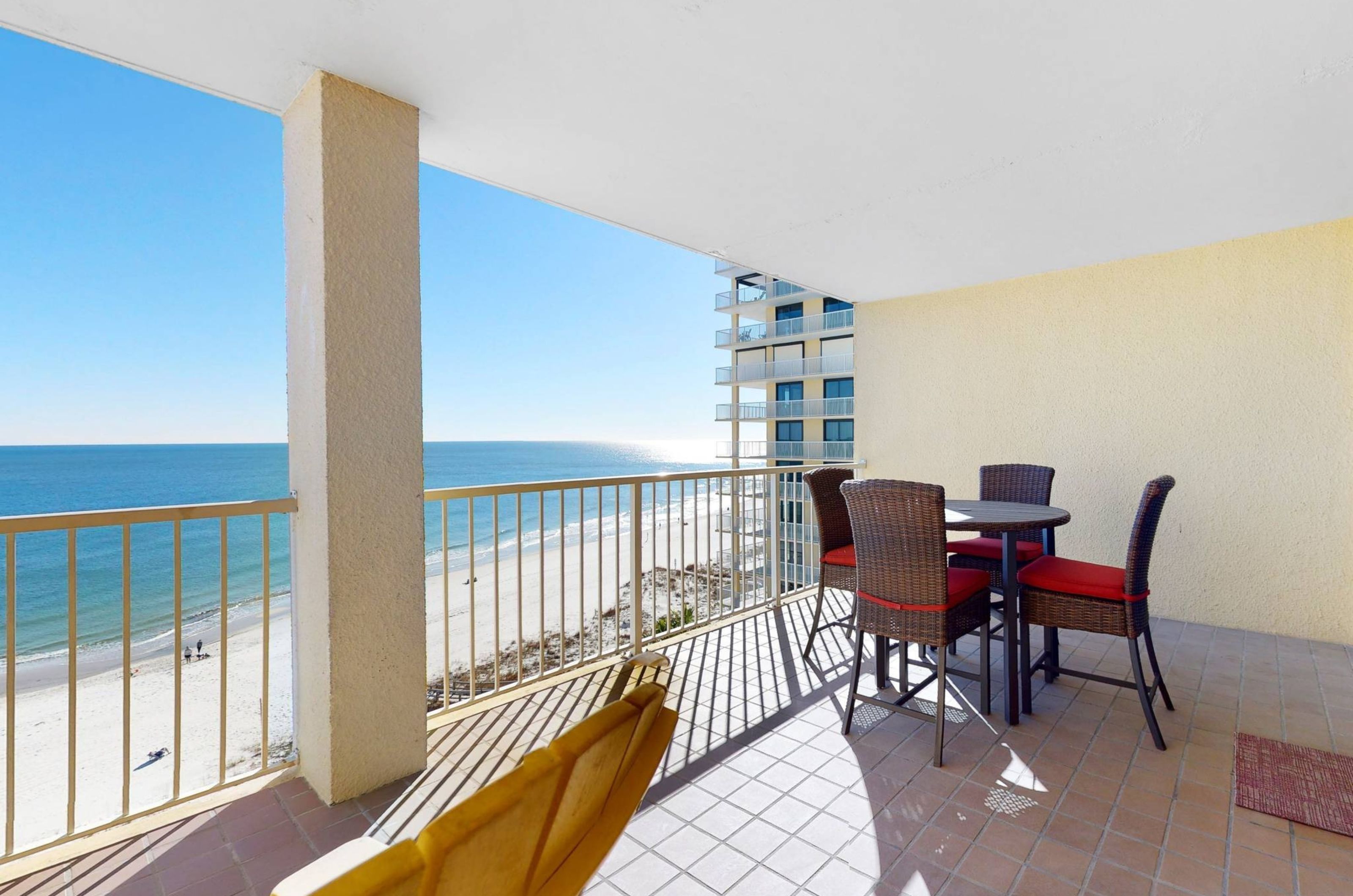 A private balcony with chairs and a table overlooking the Gulf	