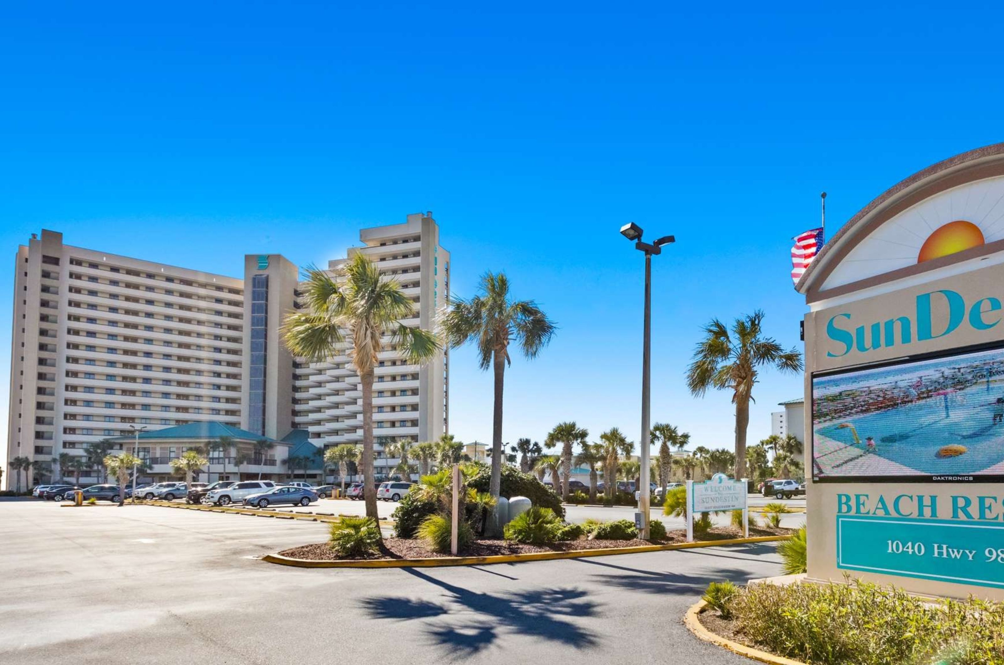 View from the street of SunDestin Beach Resort with the property's sign out front 